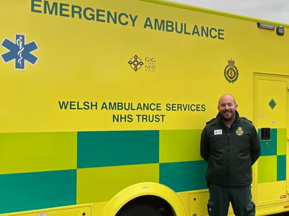 James King standing beside a Welsh Ambulance Service vehicle