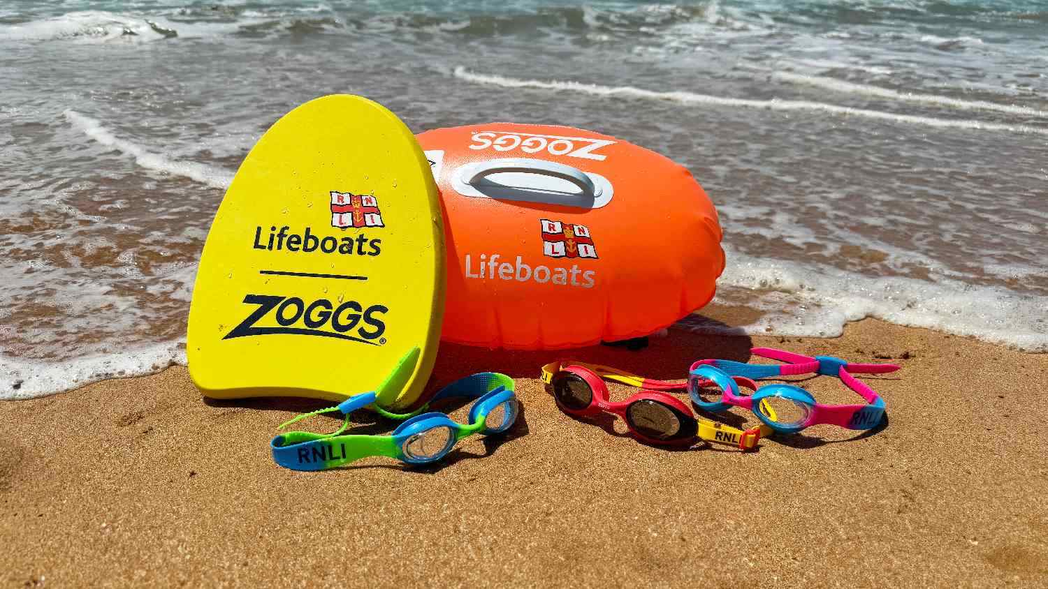 RNLI and Zoggs co-branded prodcuts which shows float, tow float and goggles