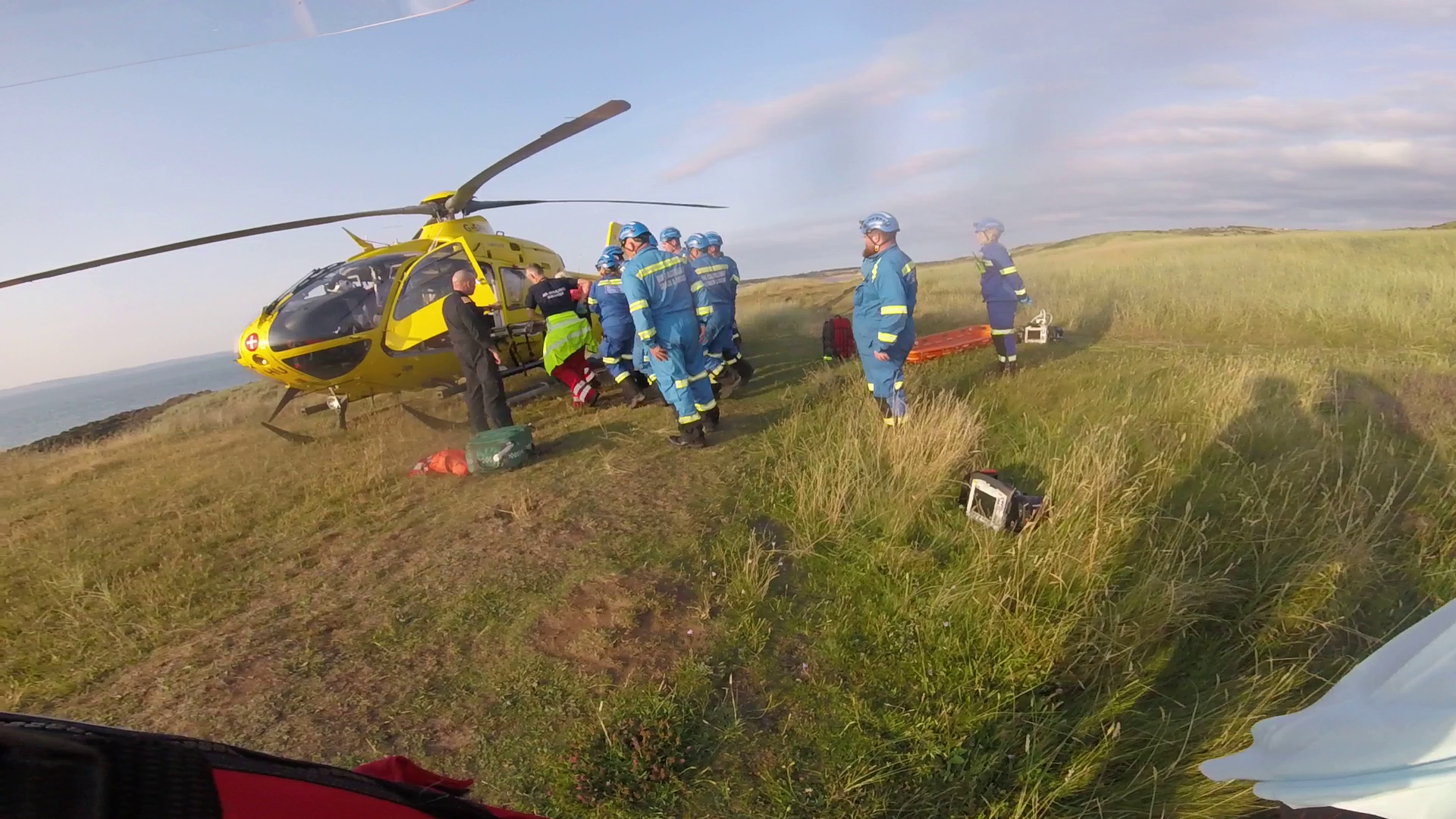 Coastguard Rescue Team Members load the casualty into Scotland's Charity Air Ambulance
