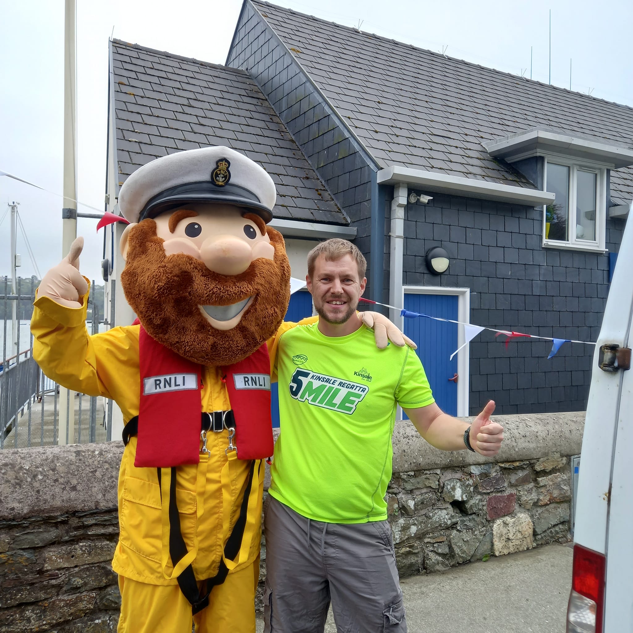 Stormy Stan and person dressed in Kinsale 5 Mile yellow t-shirt