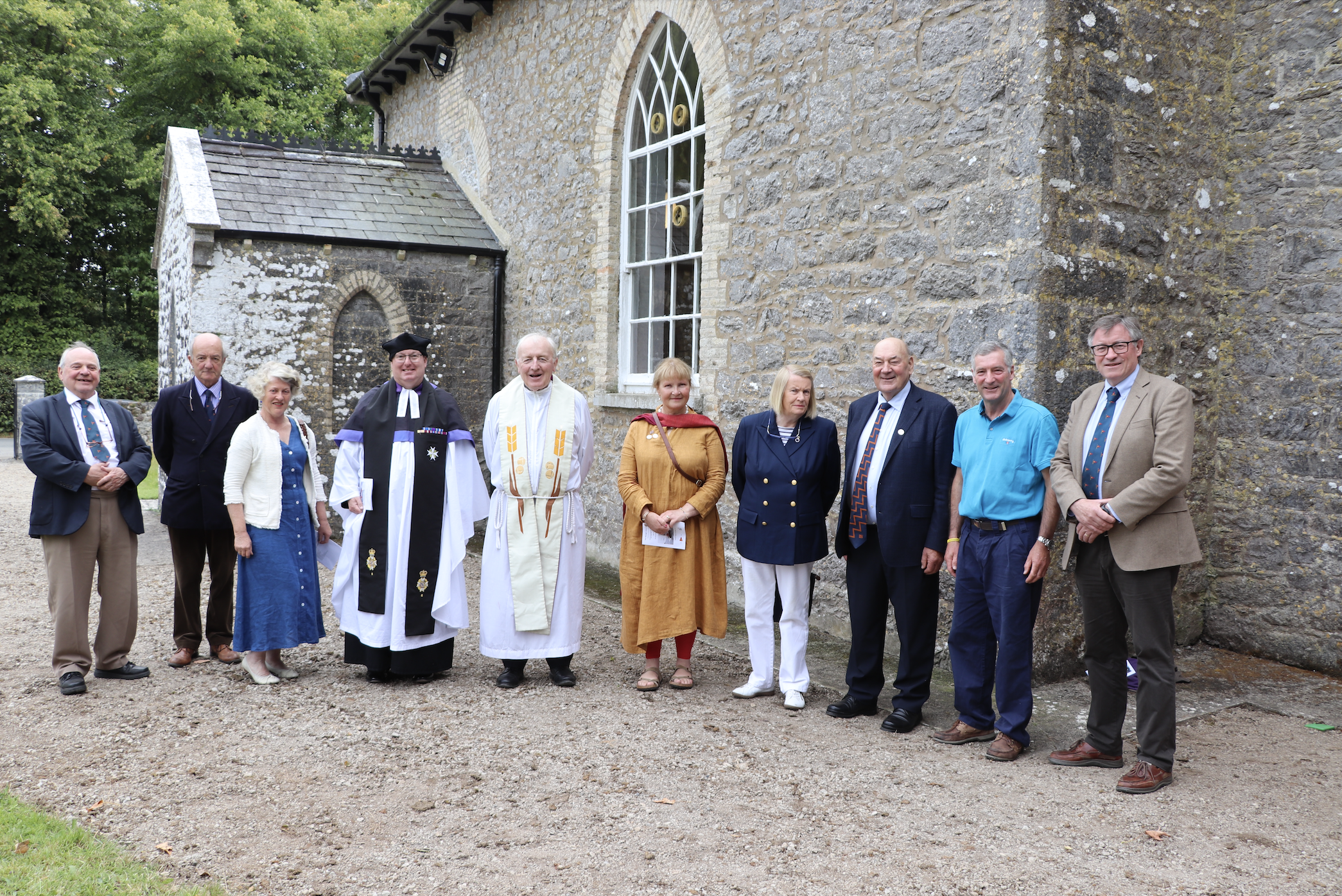 RNLI volunteers and clergy standing outside Killodiernan Church following the Service of Thanksgiving