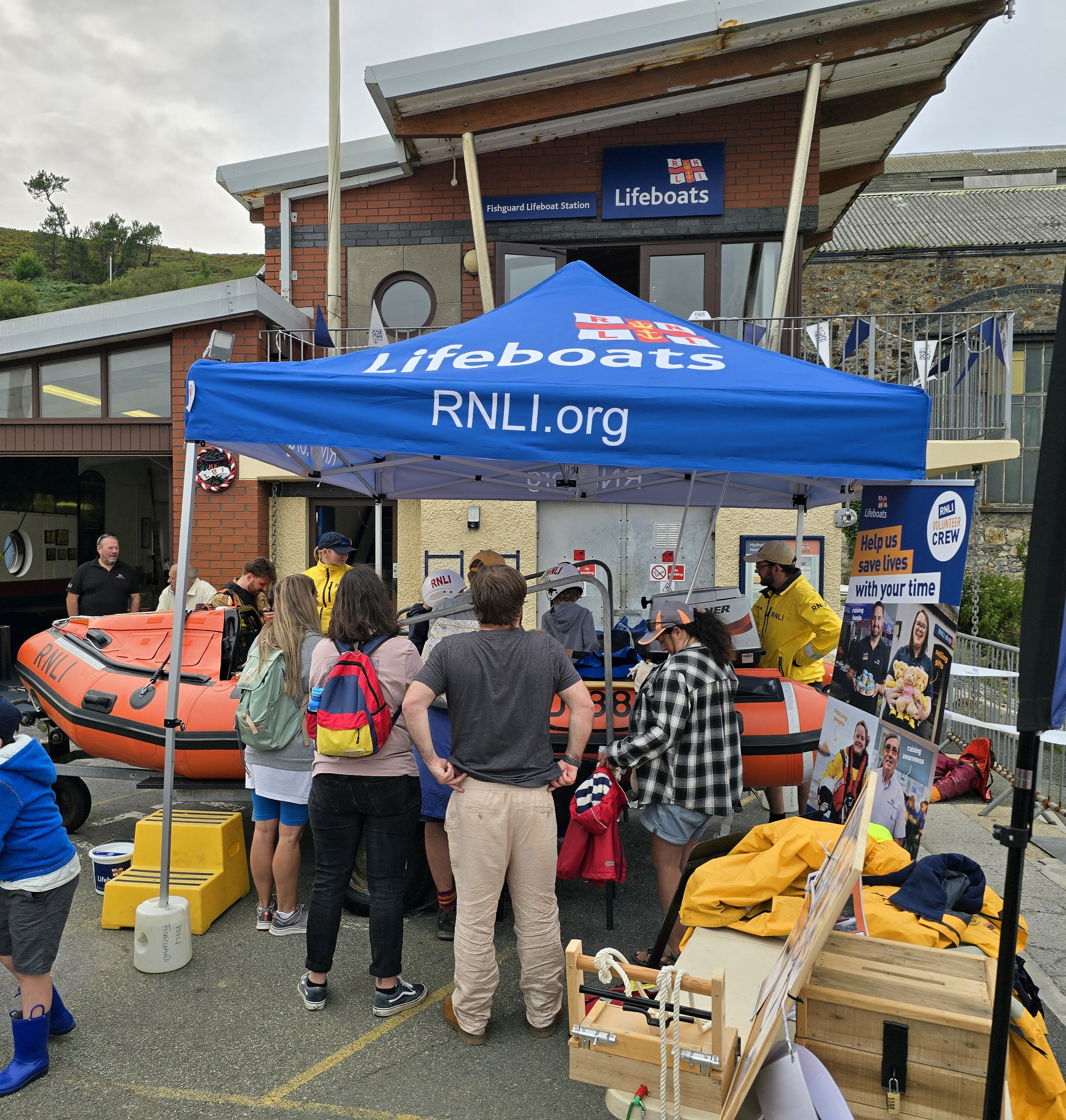 Crew telling visitors about the stations inshore lifeboat and children having the opportunity to dress in kit.