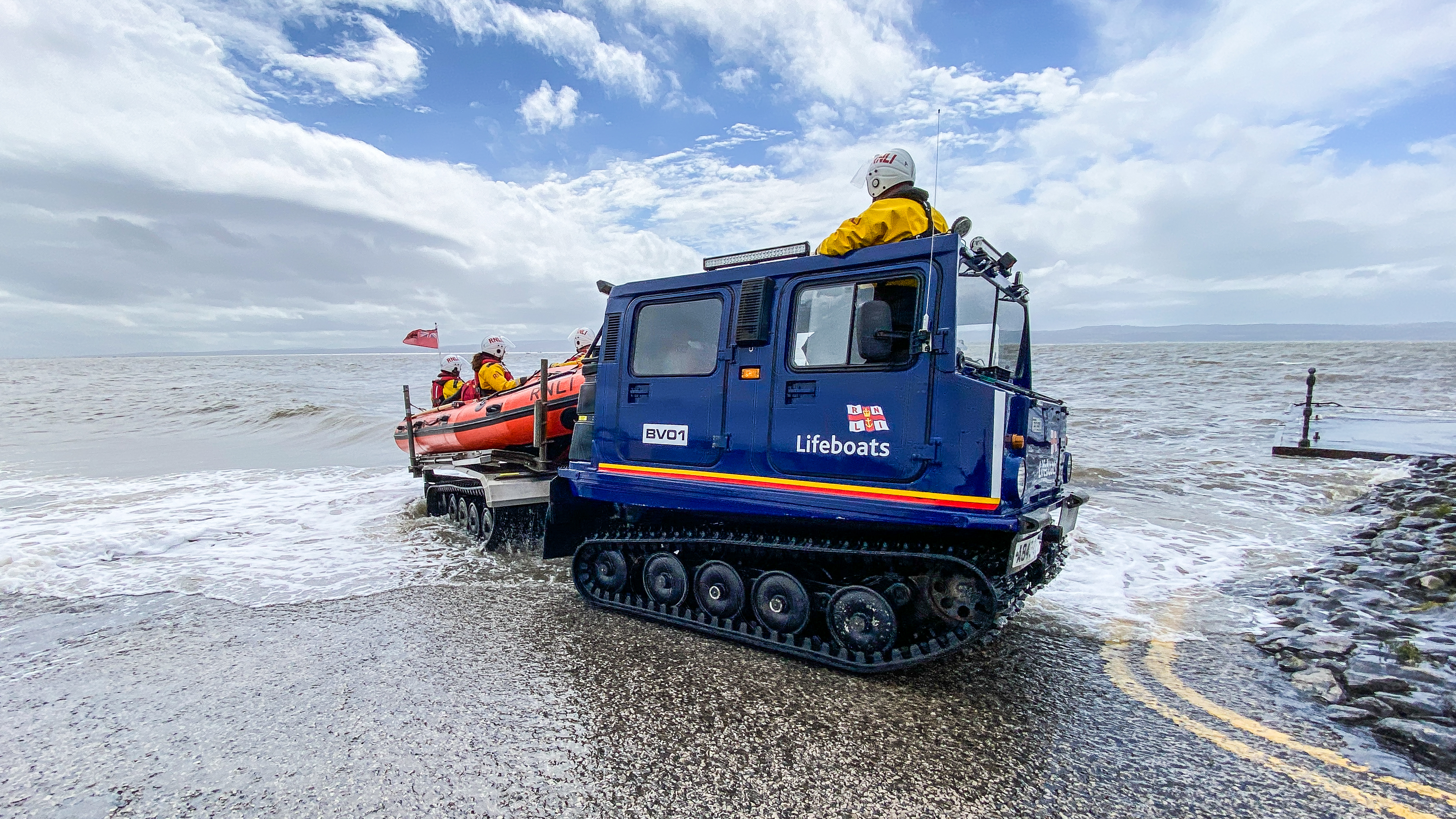 The Hagglund BV launch vehicle stands in the forefront with the D class inshore lifeboat re-joined on the back