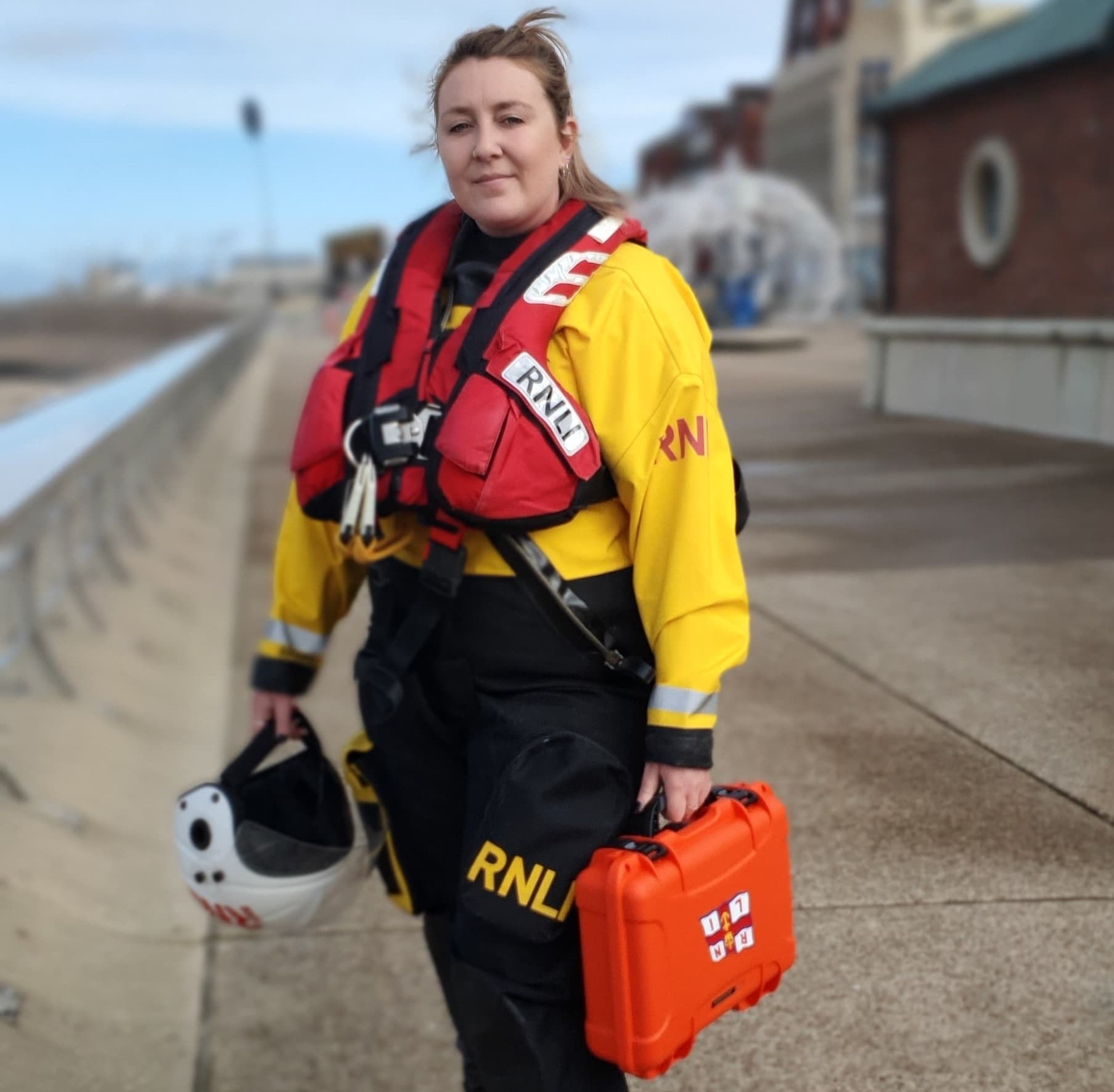 Female RNLI crew member holding time capsule case