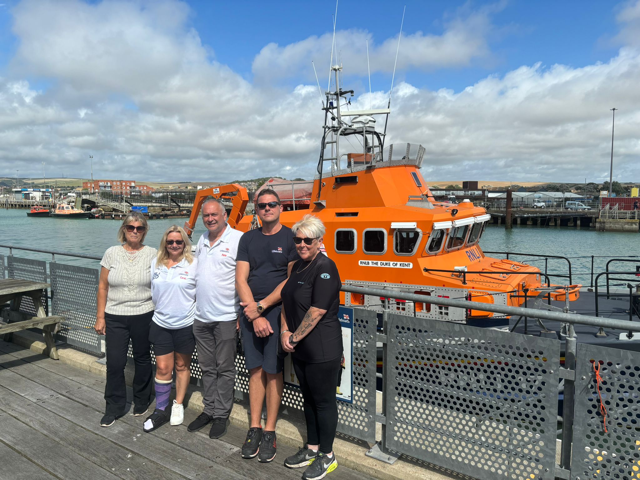 A Photo showing Pauline and Emma with Carol and Pete Shewell and Coxswain Lewis Arnold