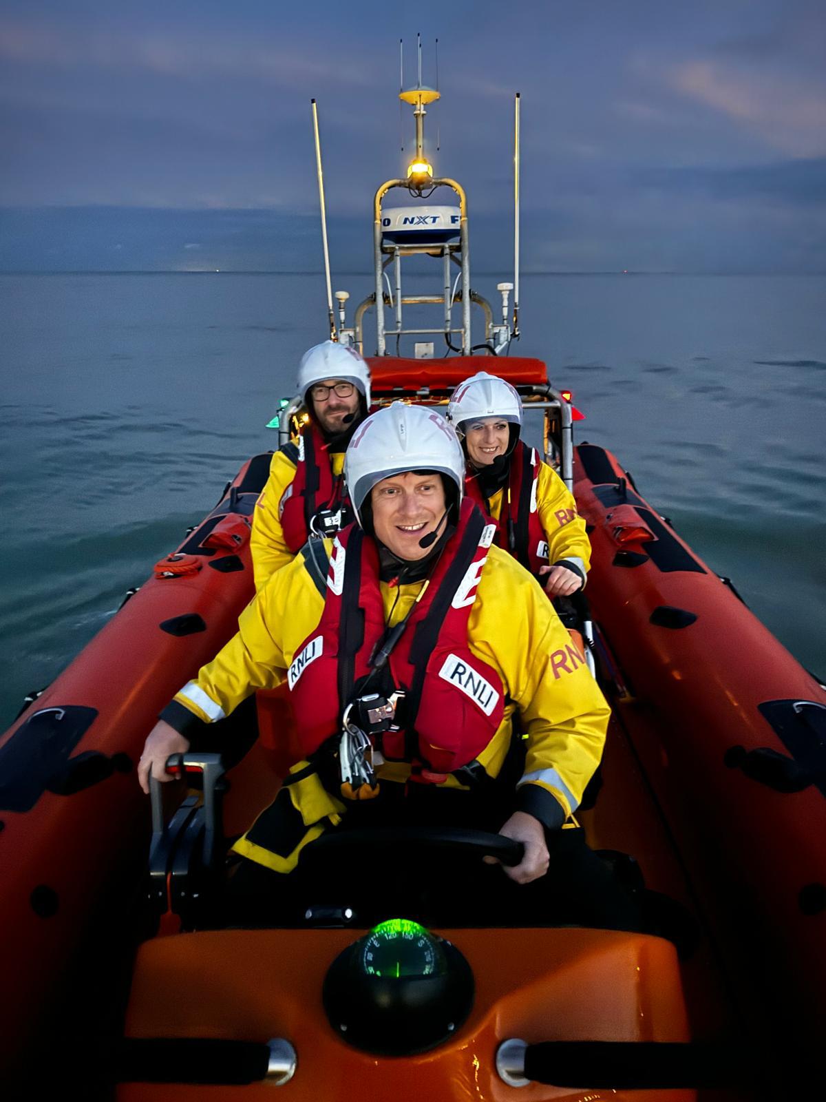 Night photo of the crew of the inshore lifeboat
