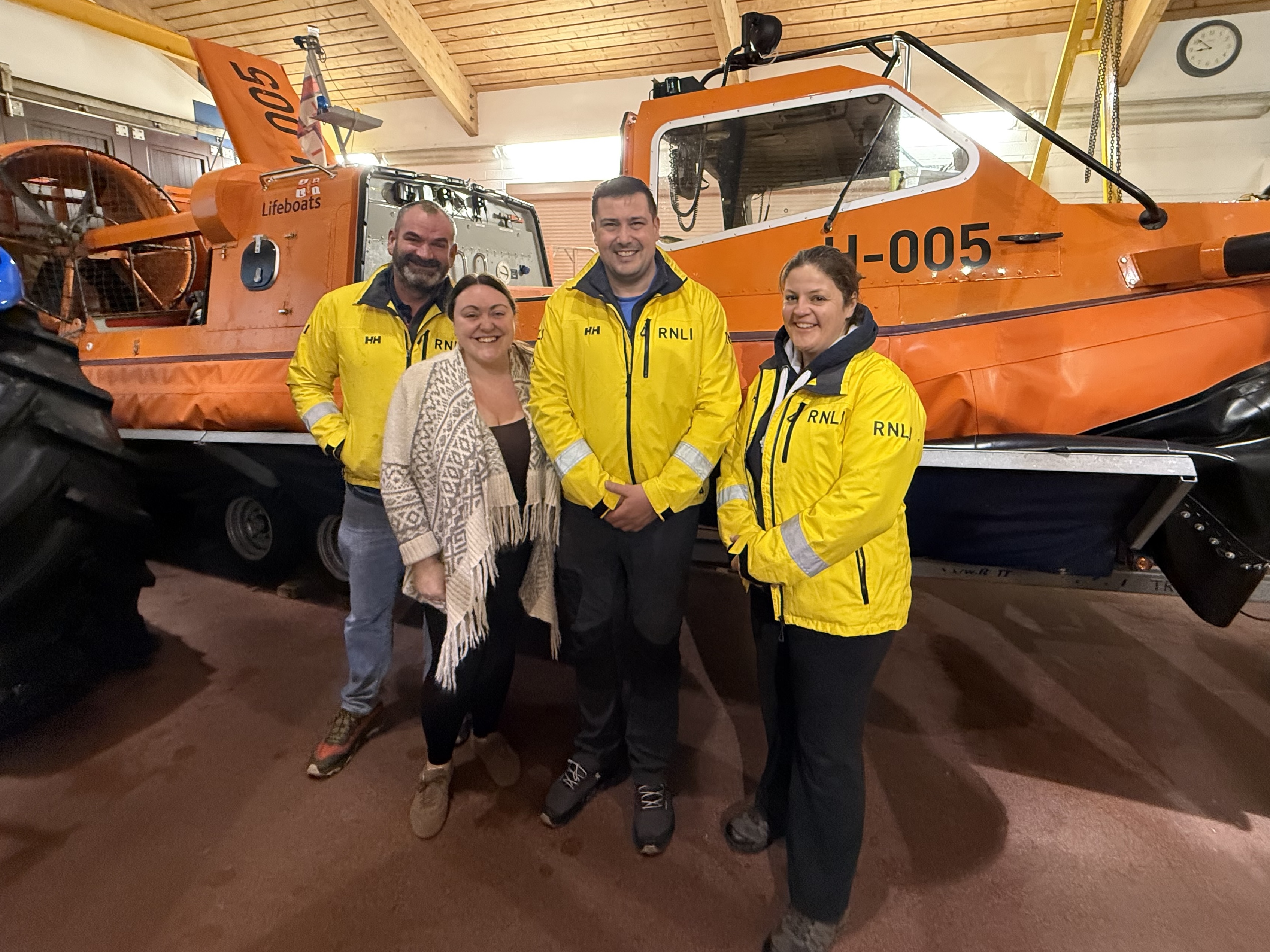 L-R hovercraft pilot Paul Sherratt, Becky Hughes, hovercraft commander Andy Dodd, and hovercraft crew member Emily Jones.