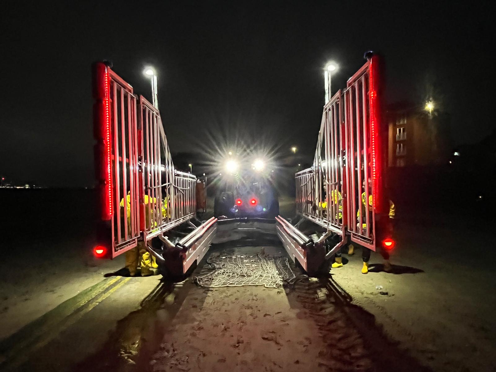 A shot from the end of the empty launch carriage on the beach. Lights from the tractor shine directly into the camera, making for an interesting glare effect.
