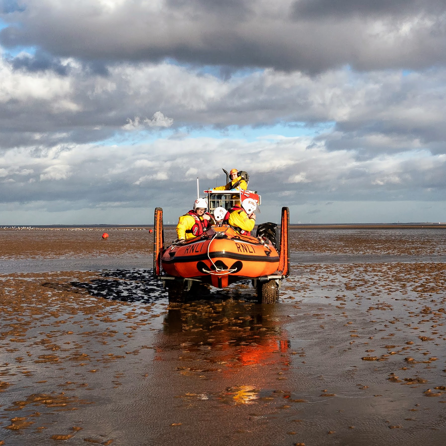D Class lifeboat on its tractor being taken across a beach by tractor (file image not from today's rescue)