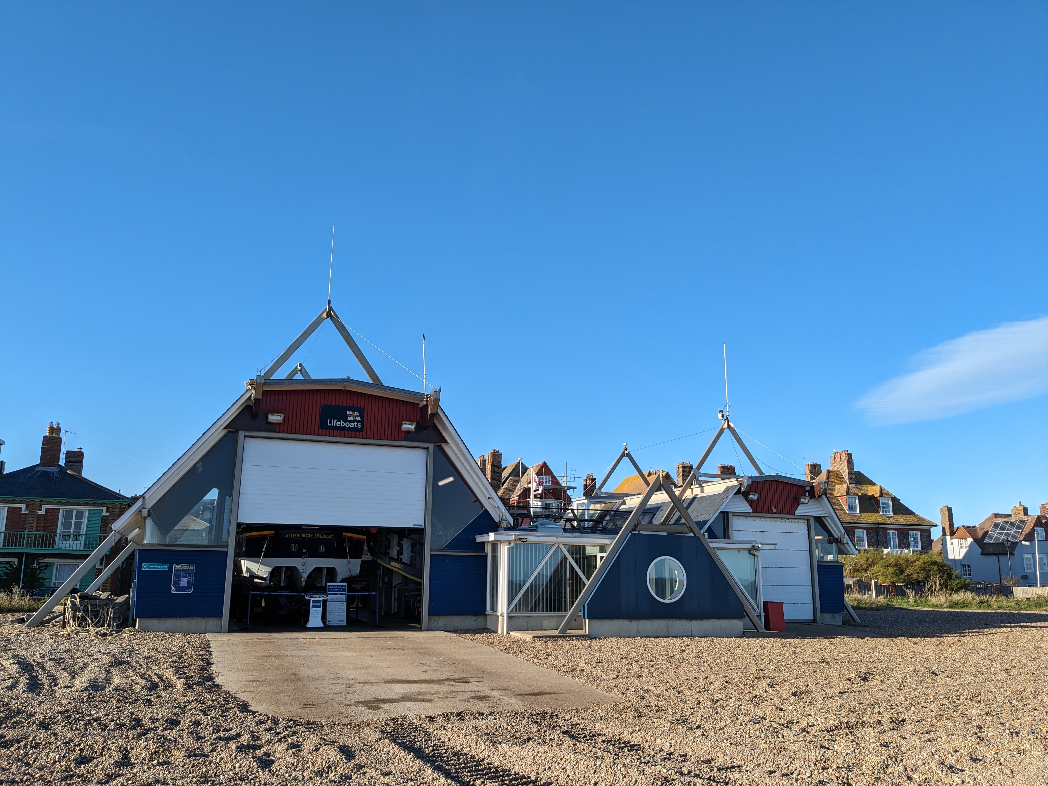 The RNLI station at Aldeburgh, from the beach on a sunny, blue sky day