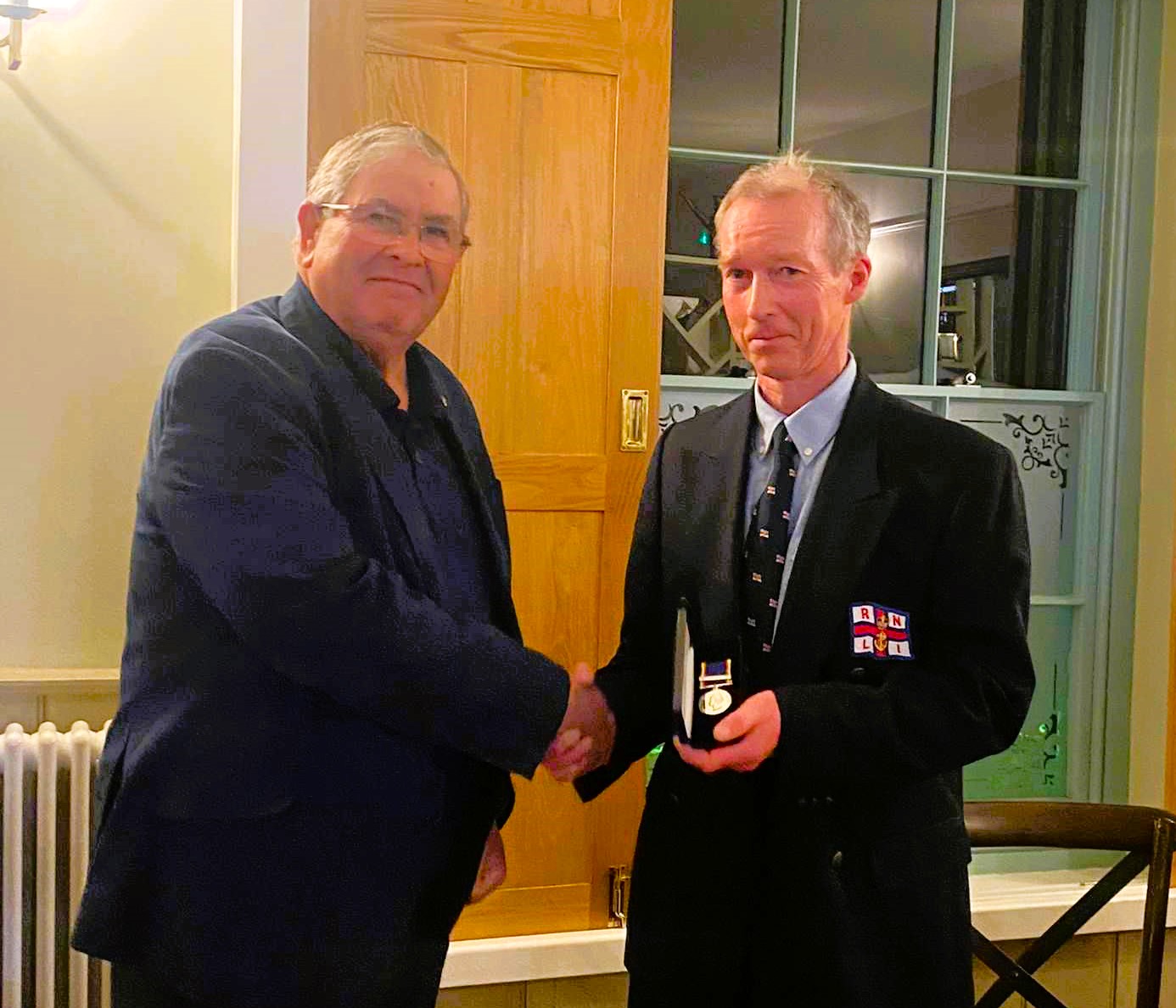 Sheerness RNLI full time Coxswain/Mechanic Paul Jarvis receiving his 30 year long service medal from Dave Brown.