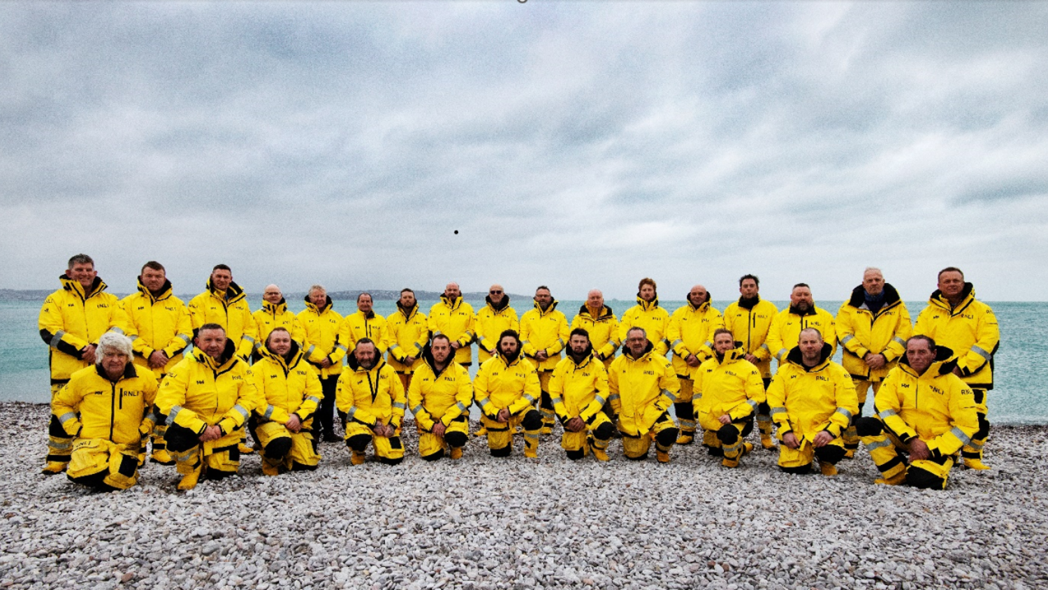 Group photo of RNLI Torbay's crew in yellow kit.