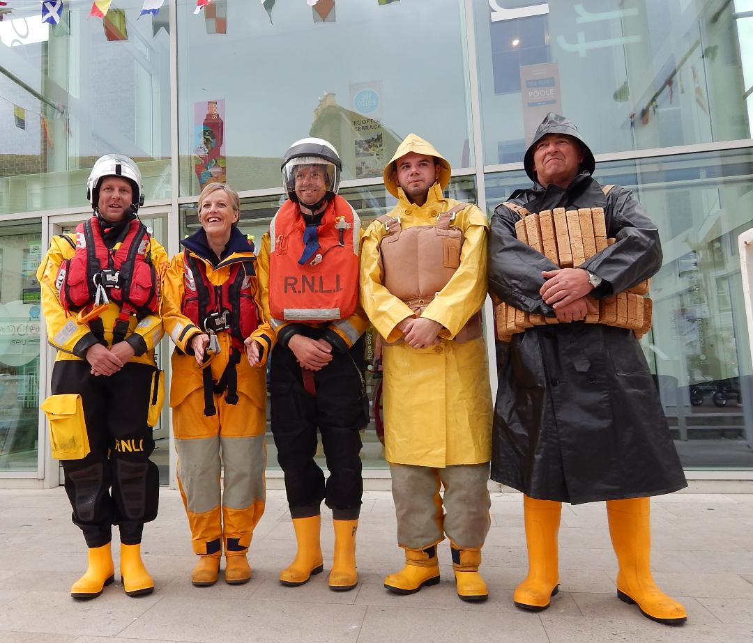 Poole volunteers outside Poole Museum in traditional lifeboat kit 