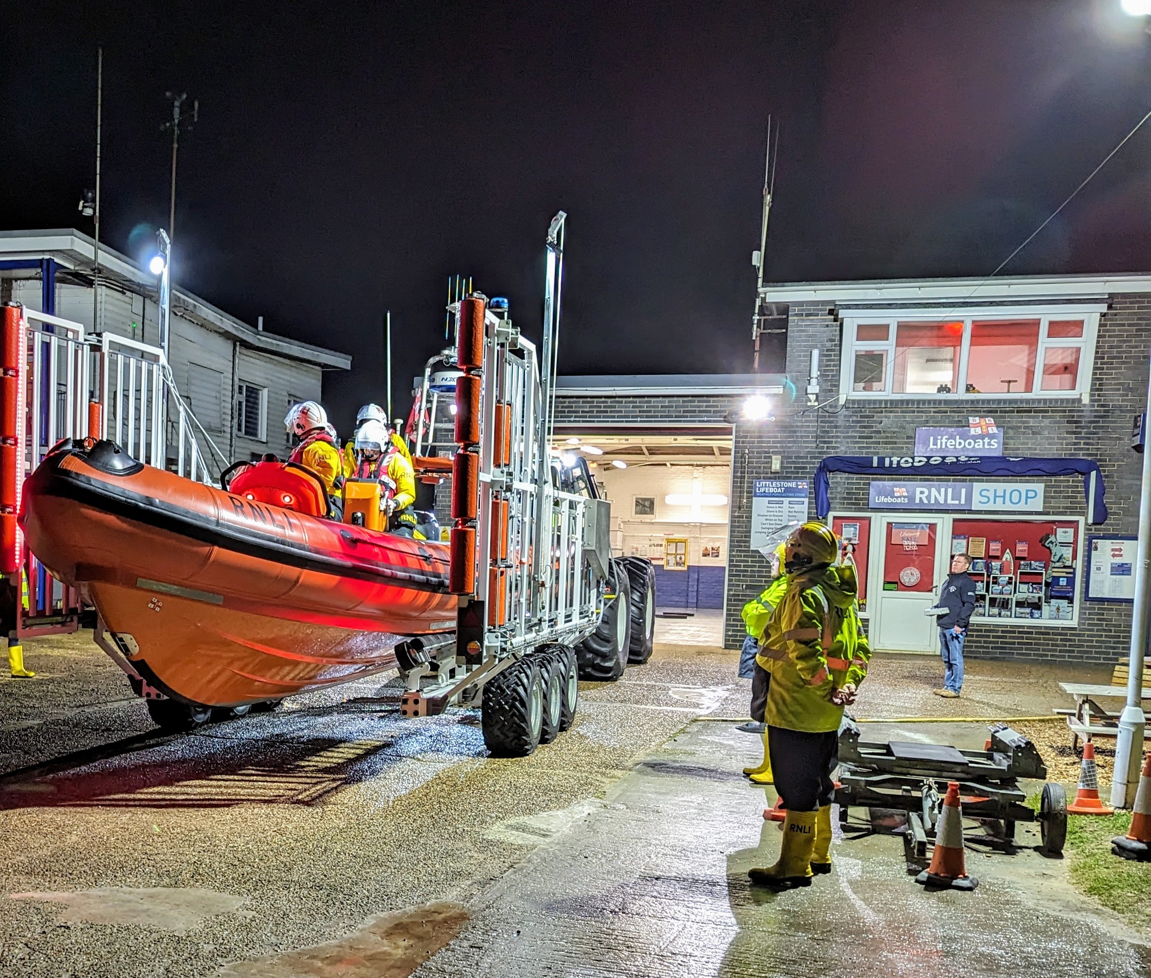 A lifeboat being rescued by the crew for launch on a dark night