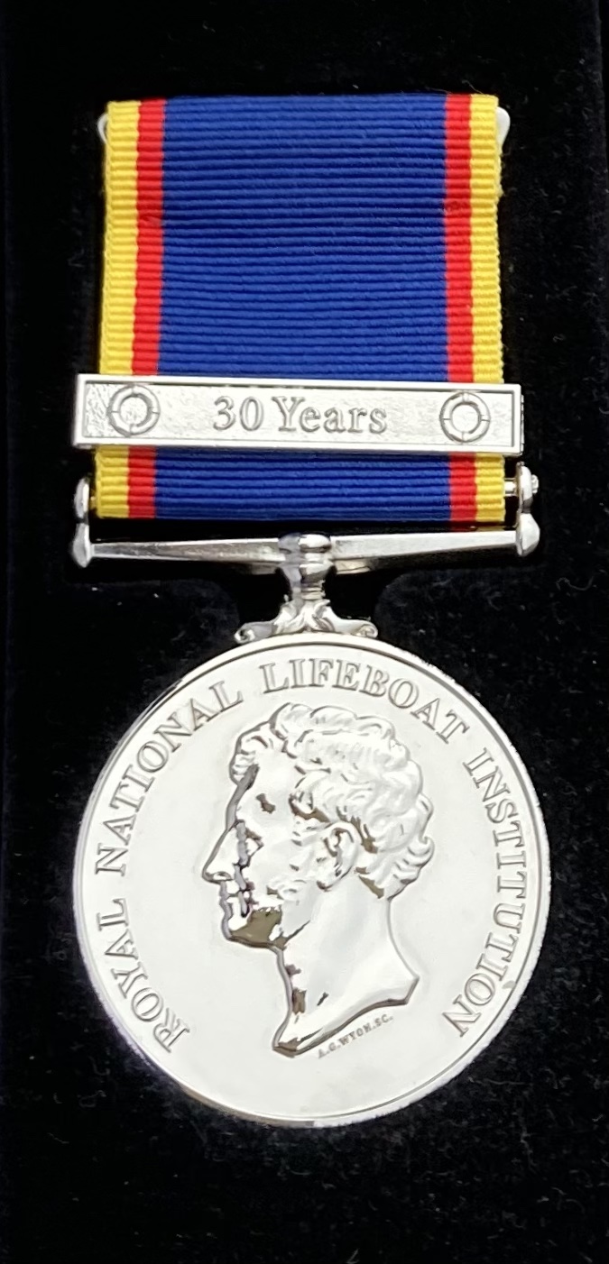 Silver medal and ribbon.