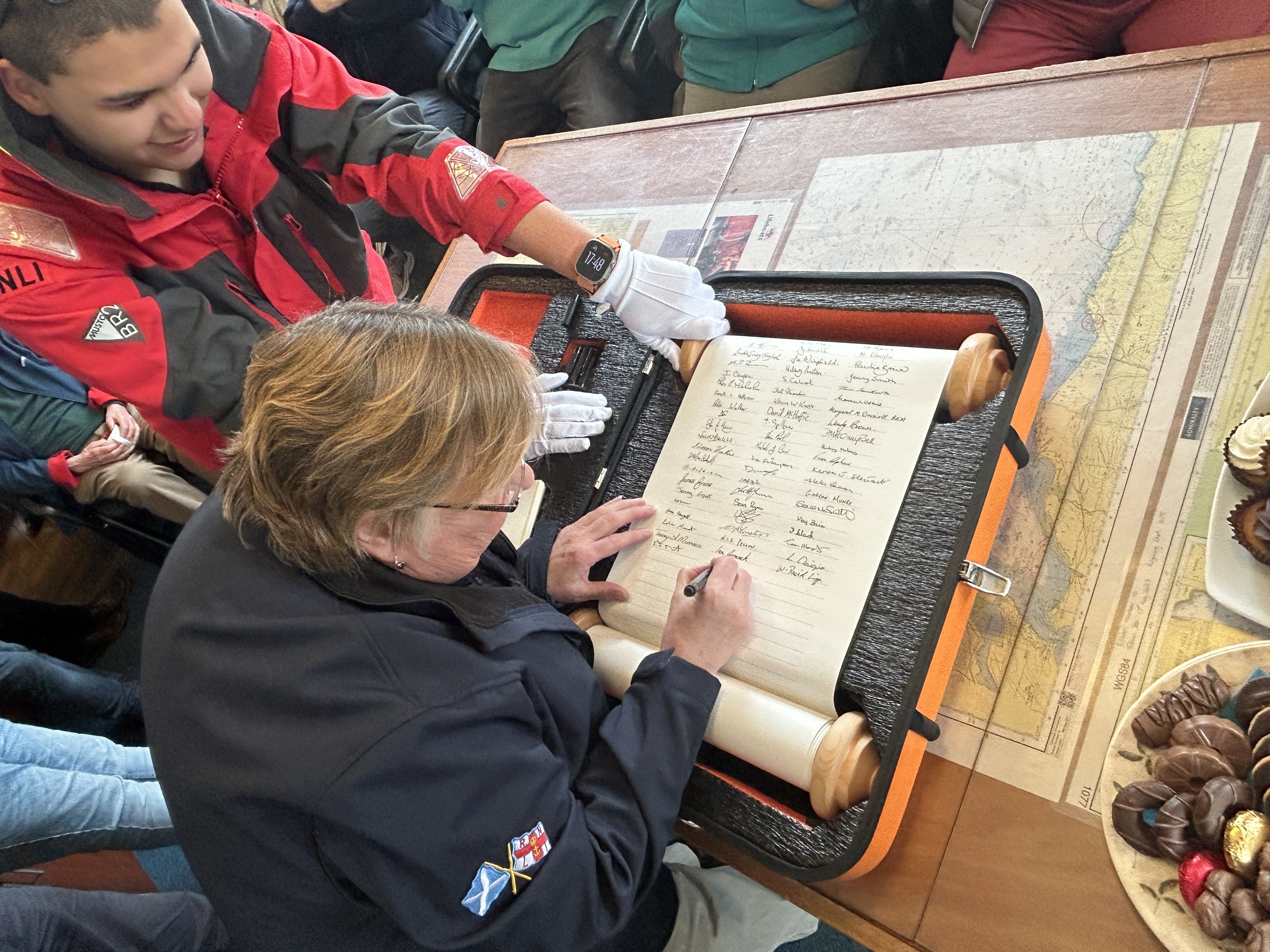 Susan Veitch signing RNLI 200 Scroll