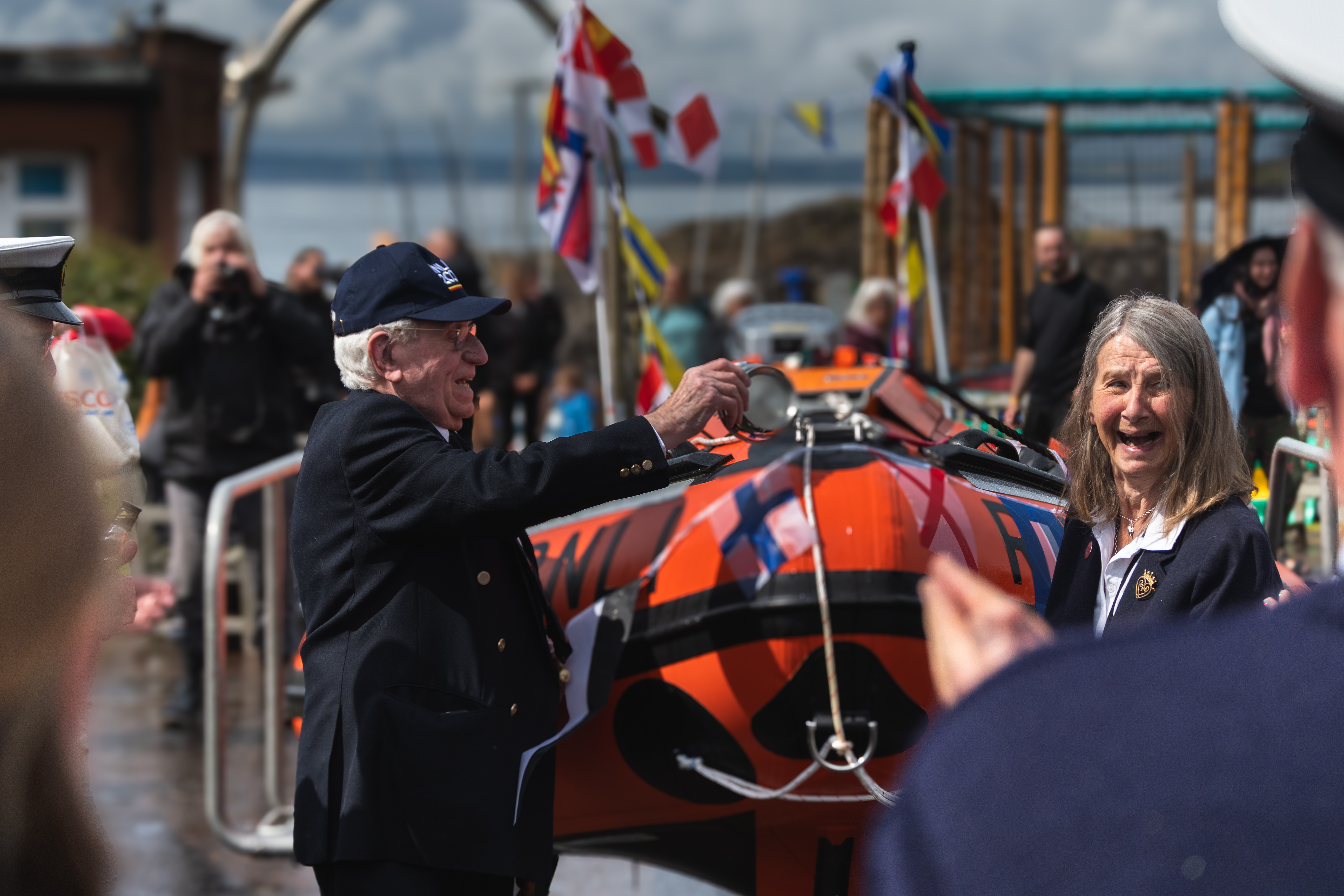 Donors pour whisky over bow of new lifeboat