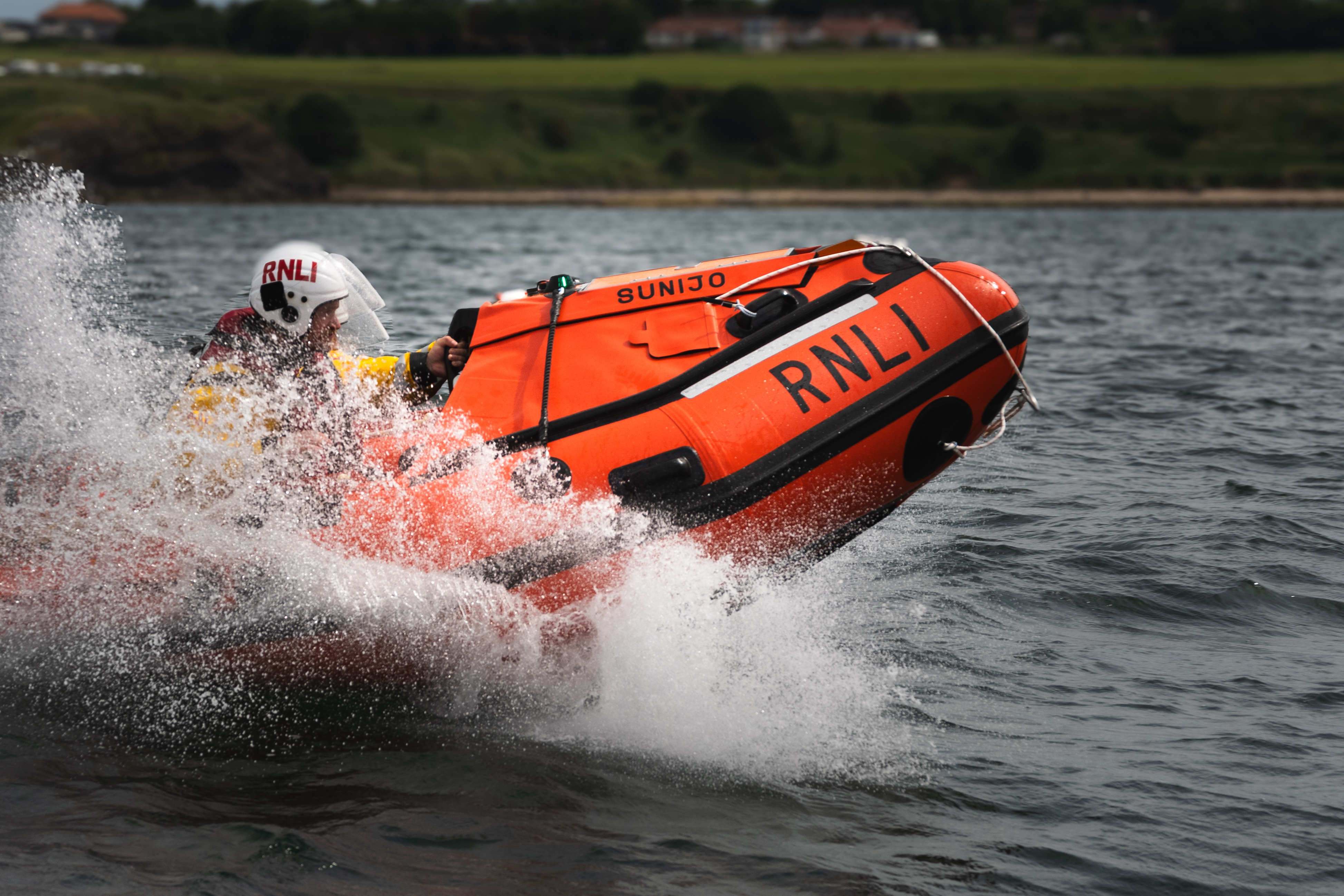Bow of lifeboat at sea with SUNIJO name 