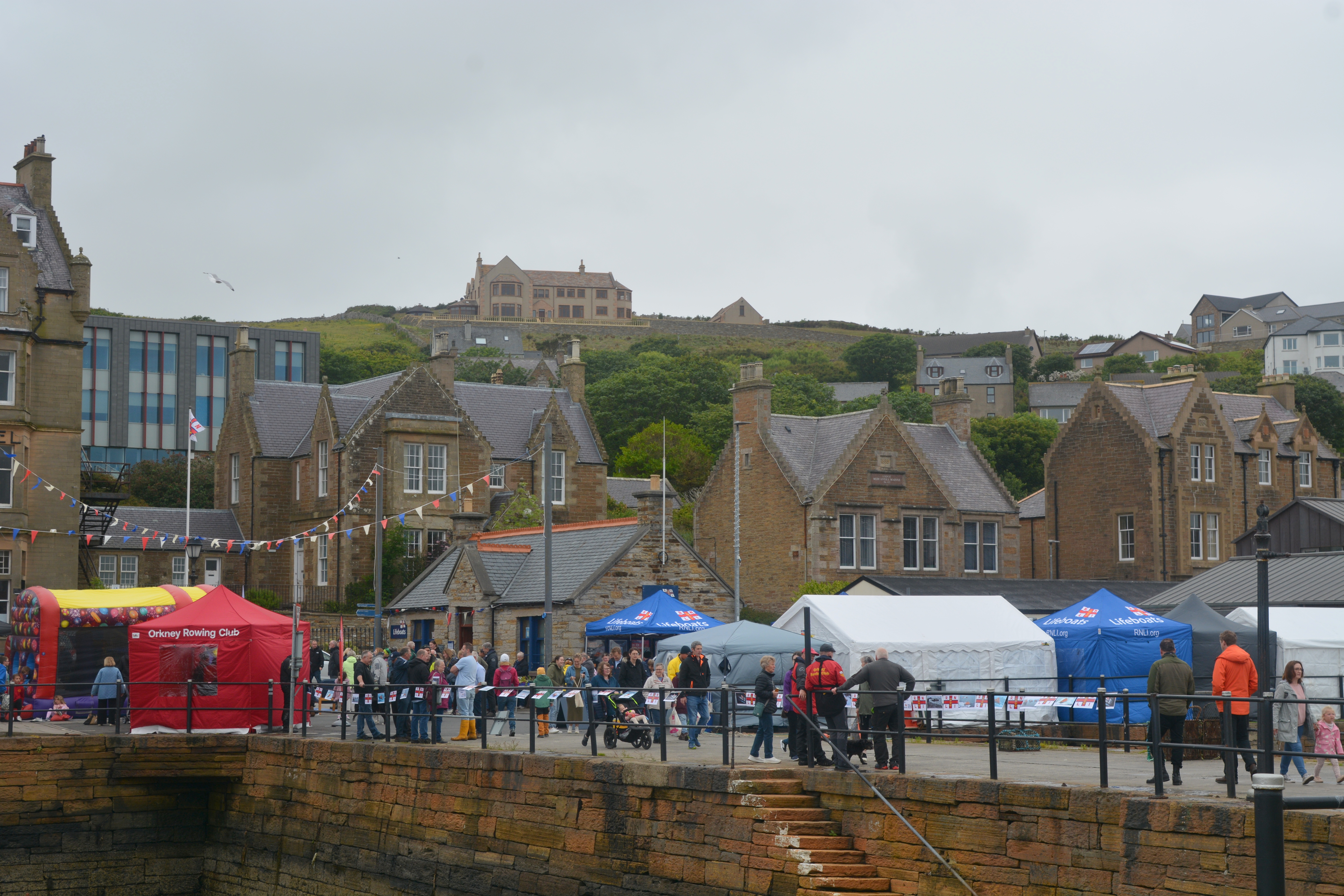 Colourful gazebos seen from across the harbour