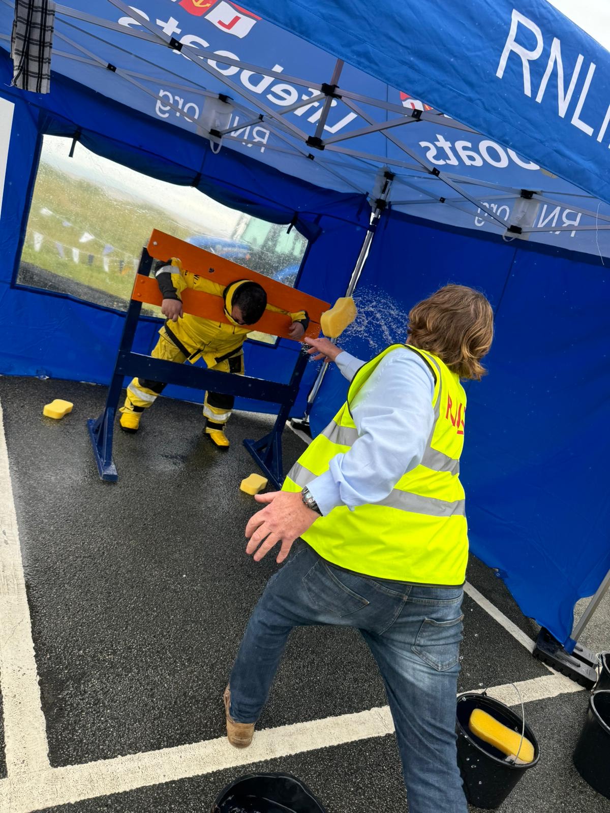 RNLI crew members take sponges to raise charity funds
