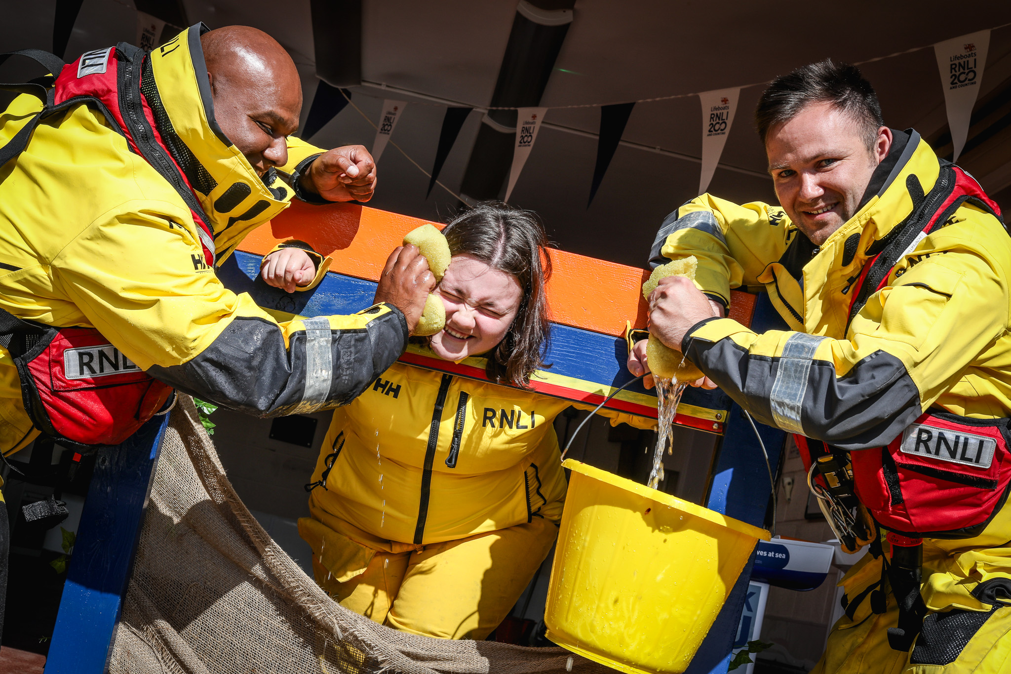 Crew members Ali Hussein and Niall Fagan soak Emily Clarkson in the Flag weekend Stocks.