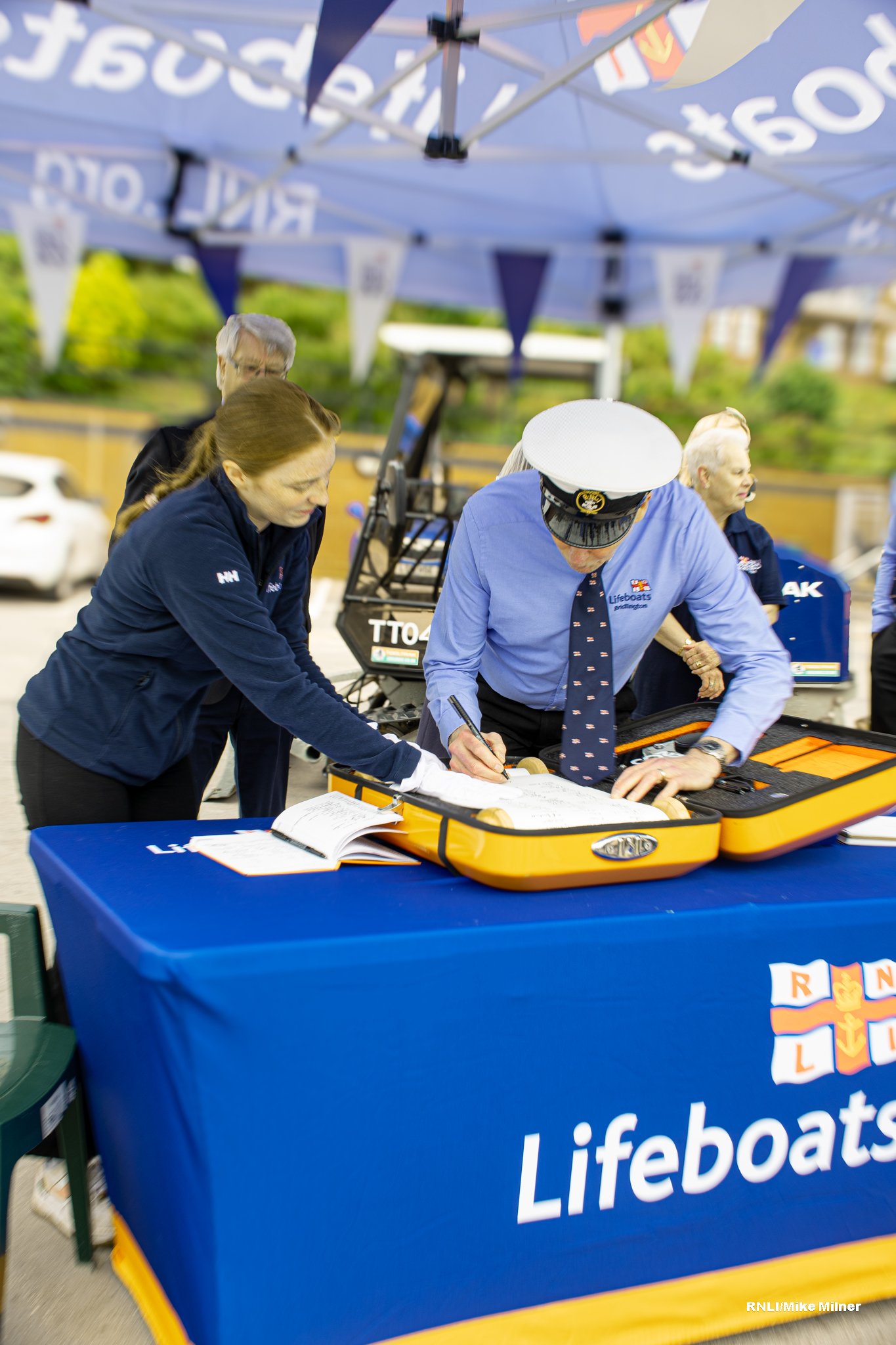 Volunteer Coxswain Steve Emmerson first to sign the RNLI scroll.