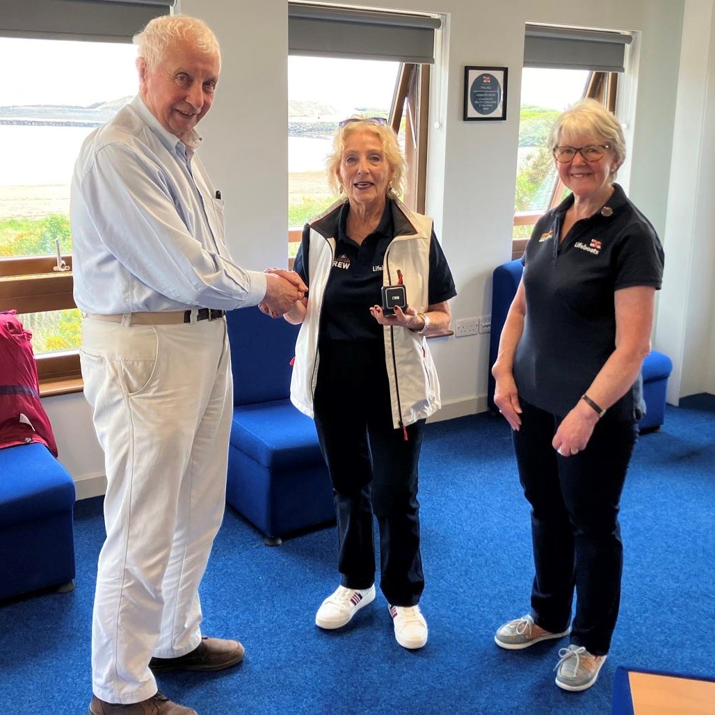 Jill receiving her medal (from L-R Roger Smith, Jill Roberts, Alison Hayes [Pwllheli RNLI Chair of Fundraisers])