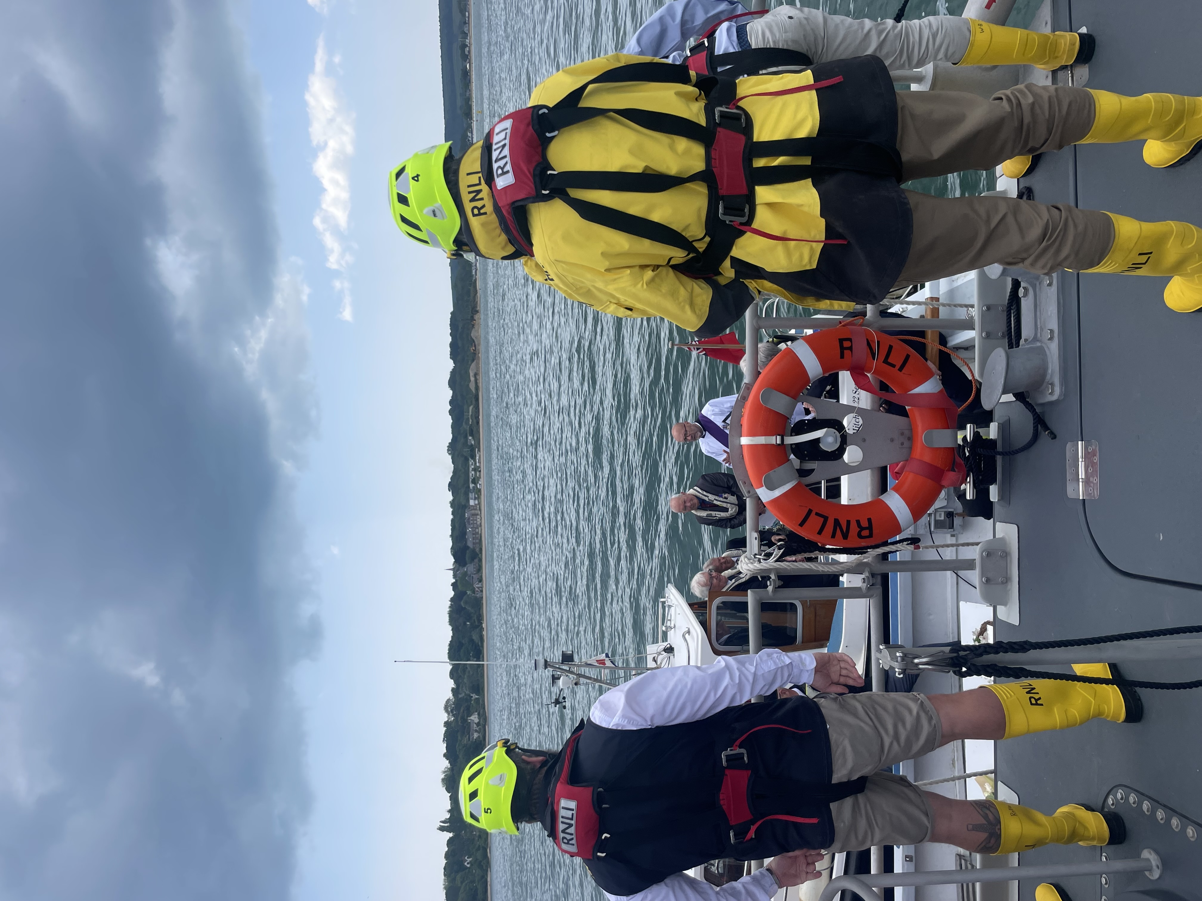 Two crew members onboard looking out at sea at laying of the wreath