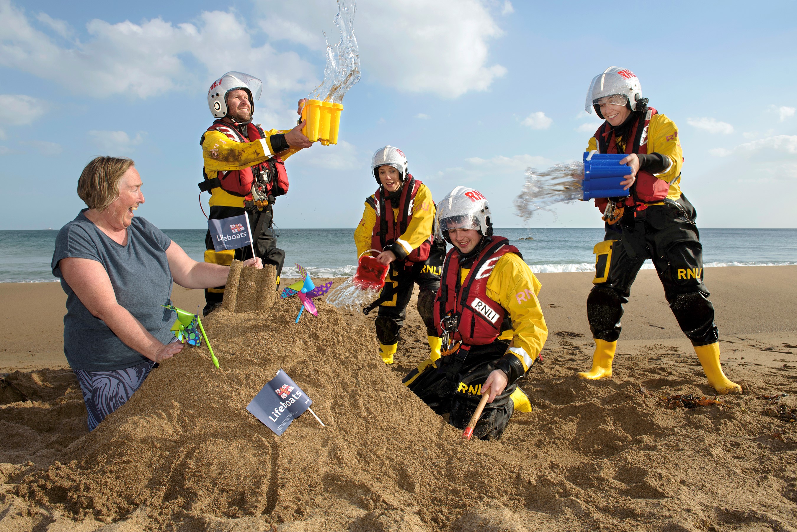 Local artist and Wexford woman Helen Mason is joined by volunteer lifeboat crew from Fethard RNLI to launch Be by the Sea. LtoR: Michael Cooper, Helen Mason, Clara Bracken, Paddy O'Regan and Trica Rice (mother with child in background, Justine MacNamara with her son Rory Haynes).