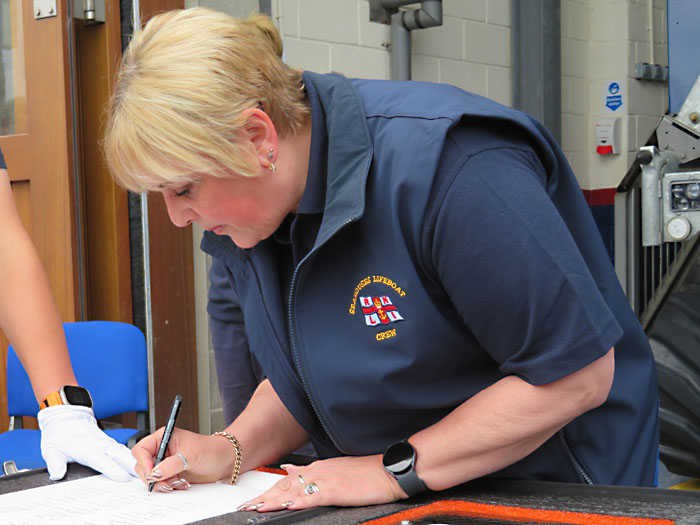 Susan Calvert Fund Raising Treasurer, signing the Scroll