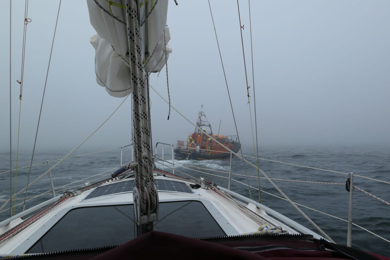 Eyemouth lifeboat 'Helen hastings' tows yacht 'Flamingo' after engine failure. The weather is heavy fog with a moderate swell.
