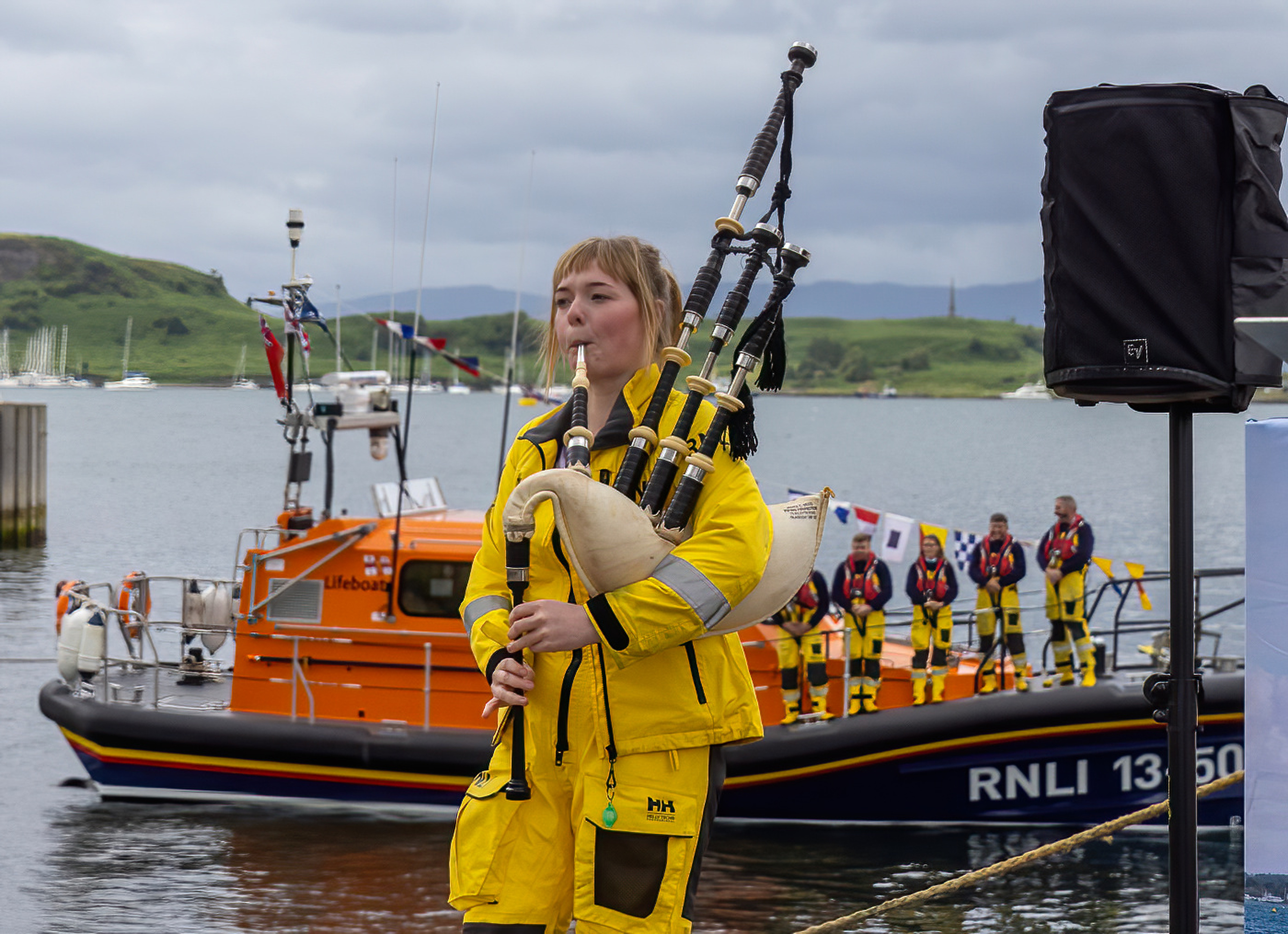 Kate MacPherson who had stood at the bow of the new lifeboat to pipe it into Oban Bay last December opened the ceremony to name and dedicate the vessel.