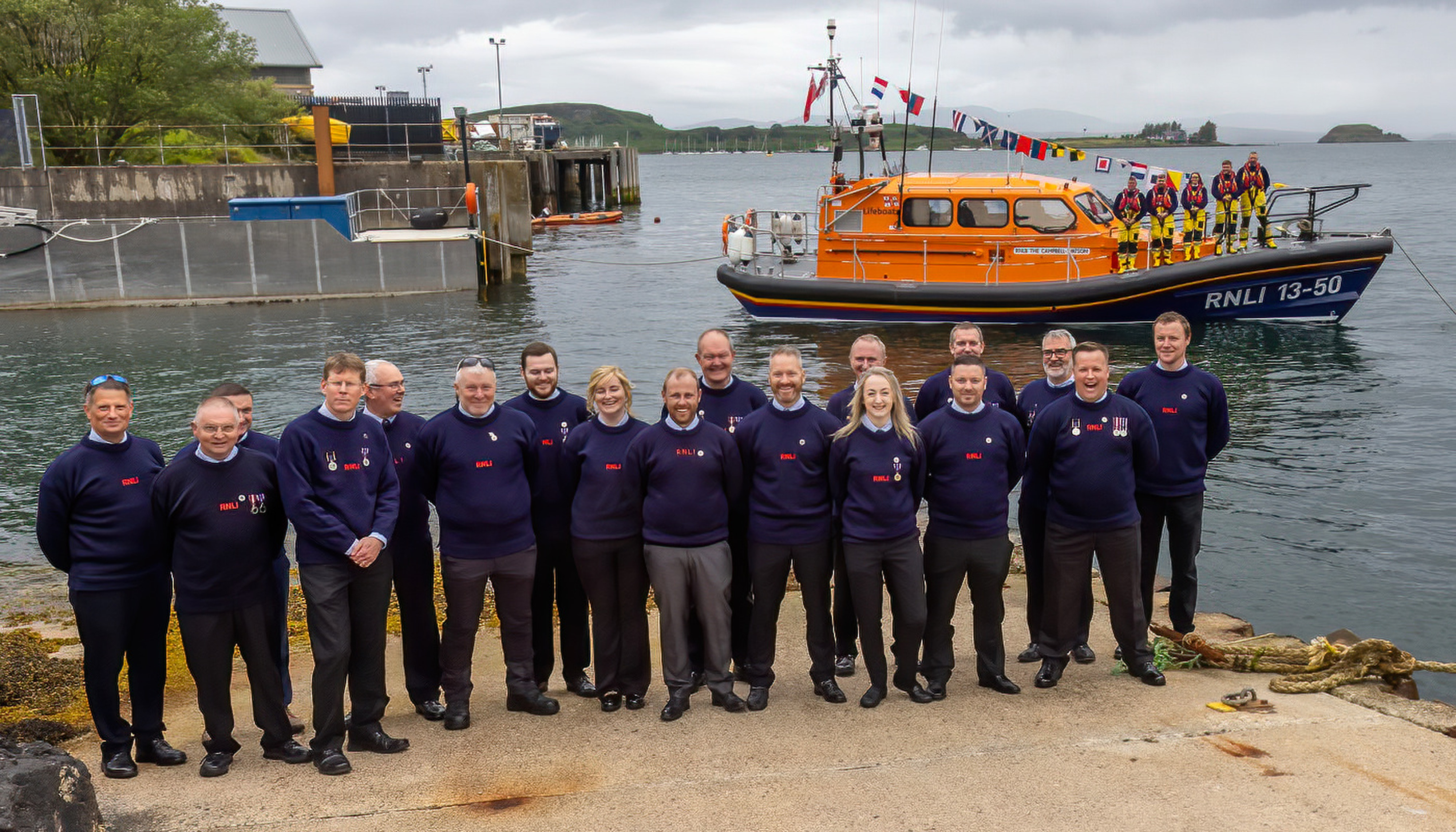 Members of the Oban Crew by the lifeboat The Campbell-Watson.