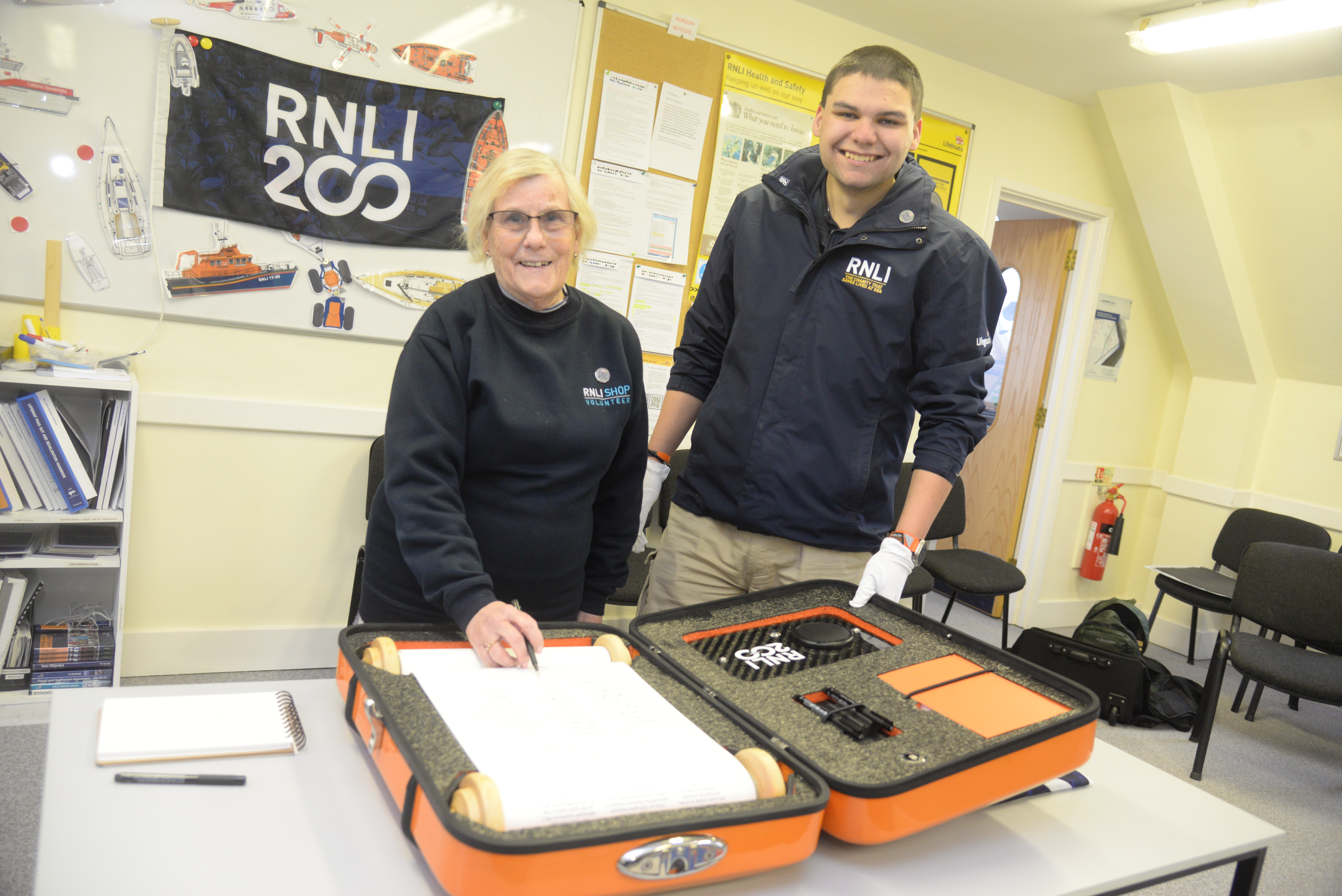 Julia Hill signed the 'Connecting our Communities scroll watched by Chris Smith who is transporting the document around the country at Whitstable RNLI on Sunday afternoon