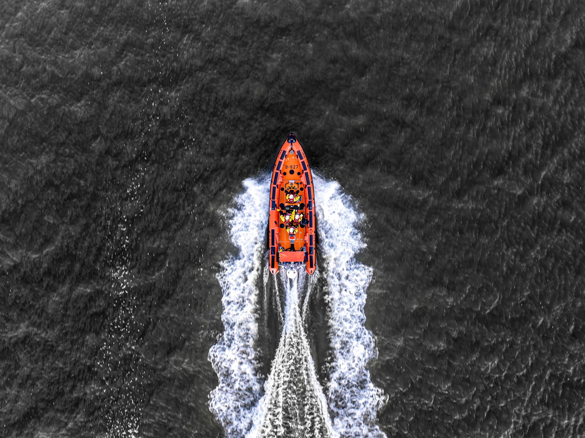 Drone shot from sky looking down on lifeboat moving