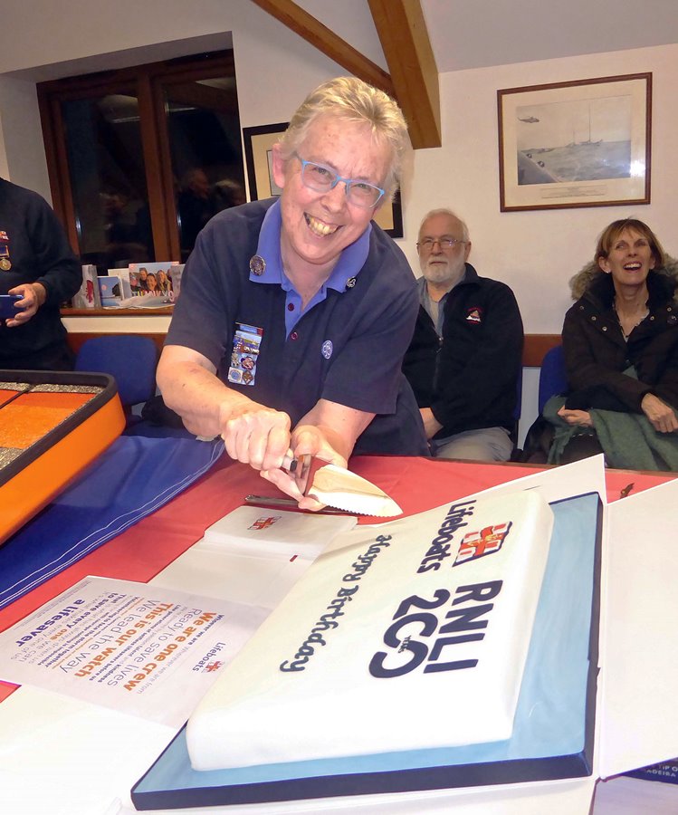 Deborah Meadows cutting the 'Birthday' cake that she had organised