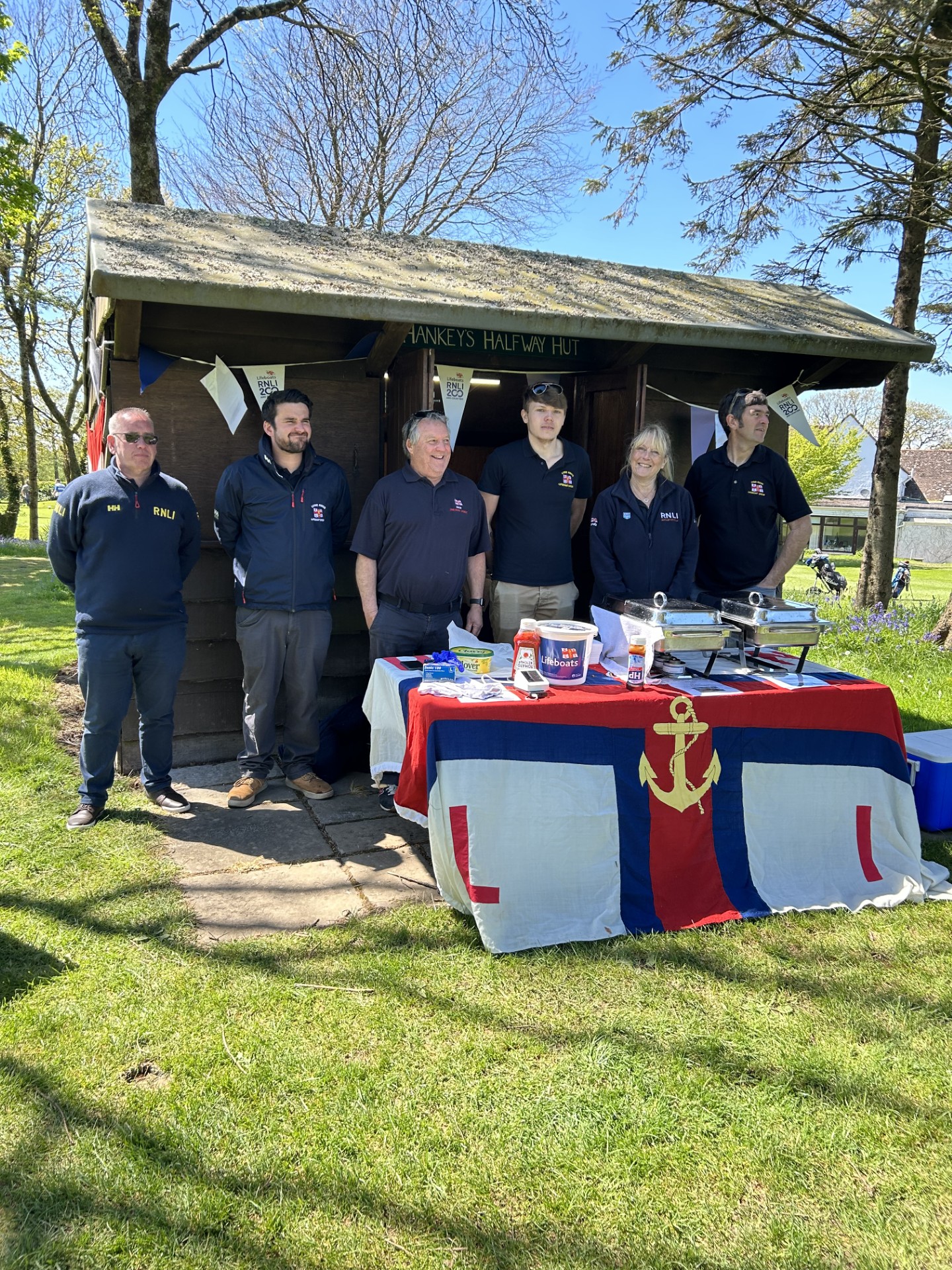 Pictures shows volunteers serving refreshments at Golf Open event