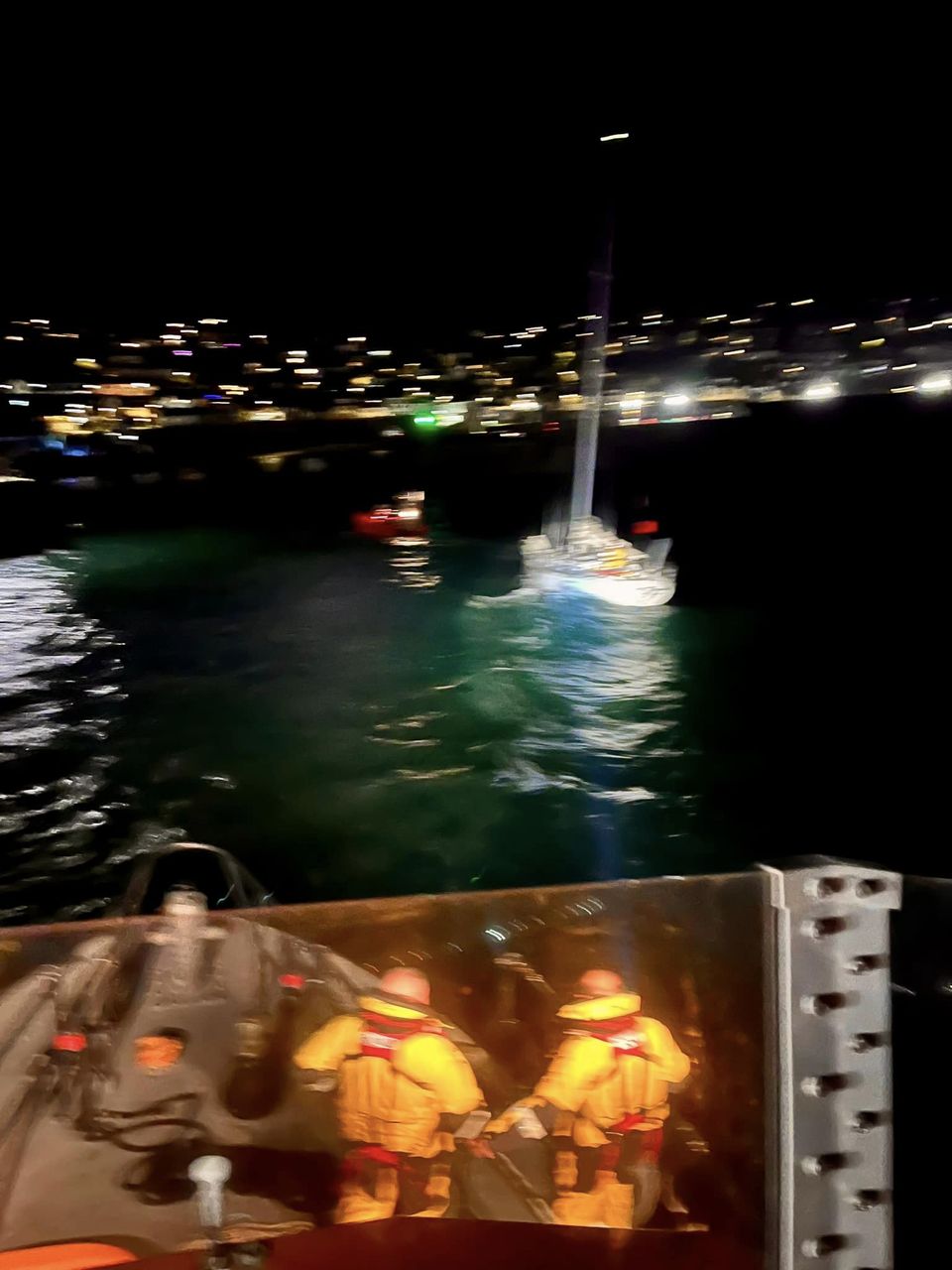 Picture shows lifeboats rescuing grounded yacht