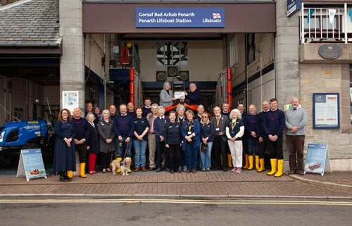 Volunteers from Penarth RNLI with Lis Burnett from Vale of Glamorgan in front of the station