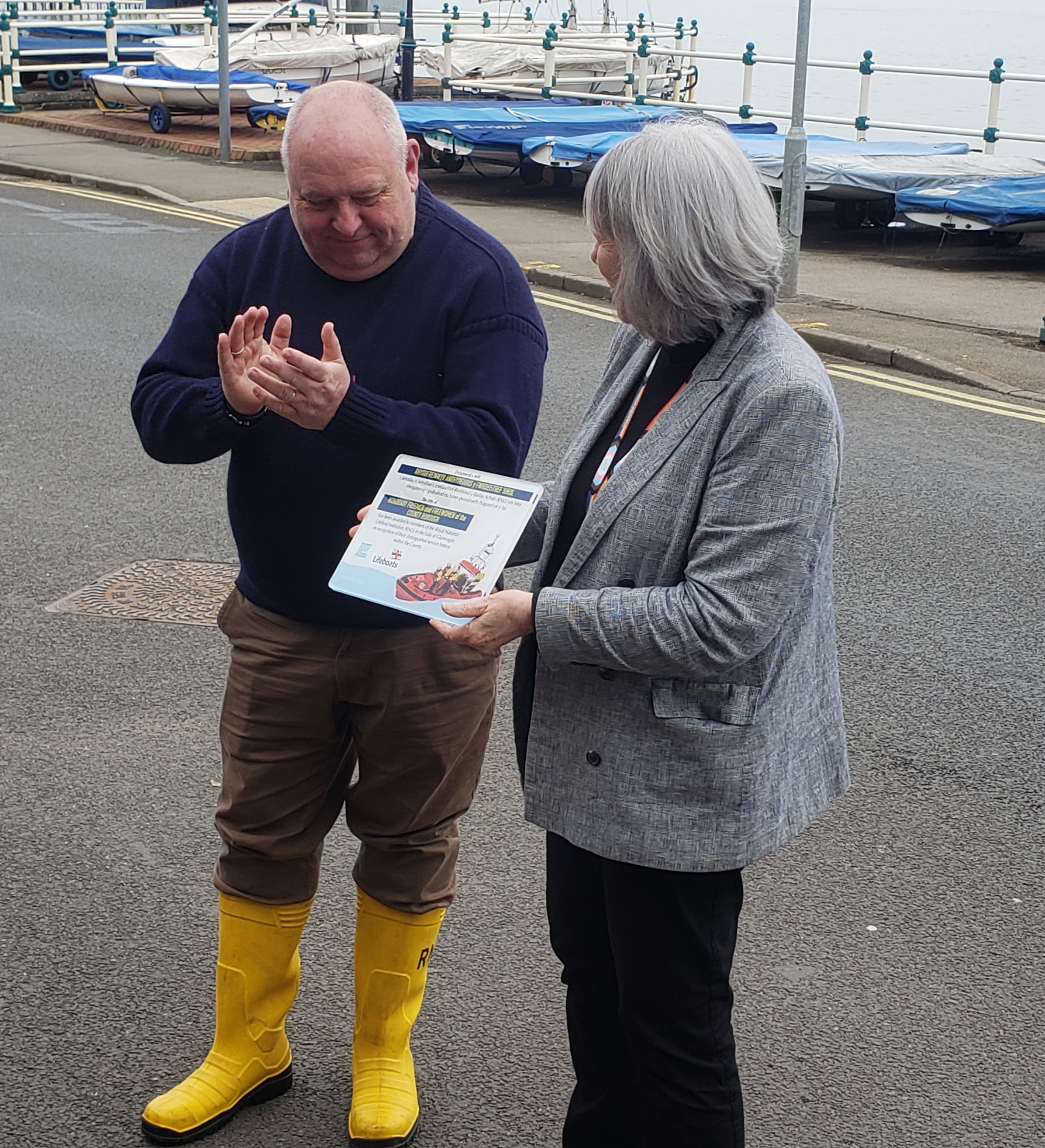 Jason Dunlop proudly receiving a plaque from Lis Burnett to acknowledge the honour of freedom of the Vale award.