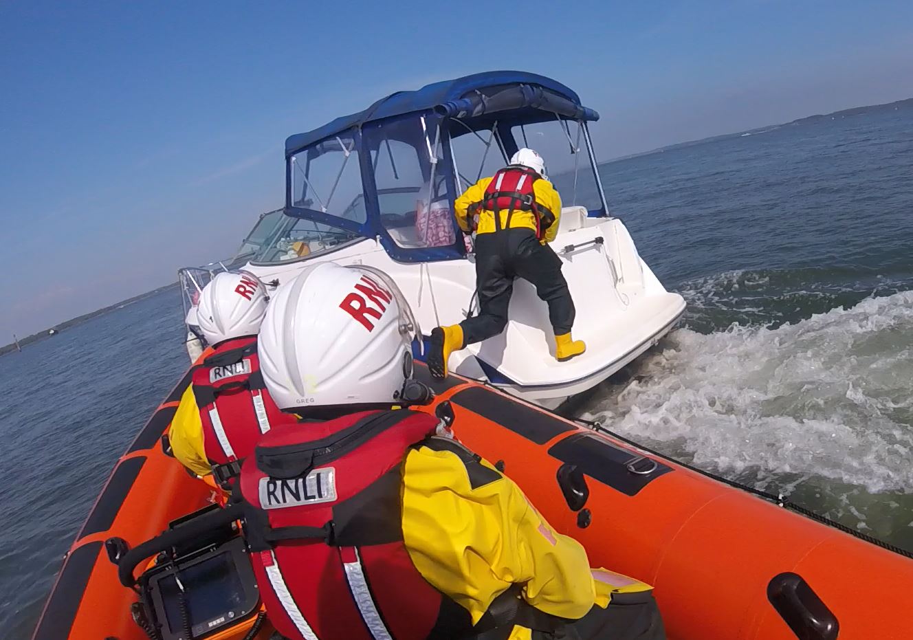Lymington Lifeboat crewman boarding the stricken vessel 