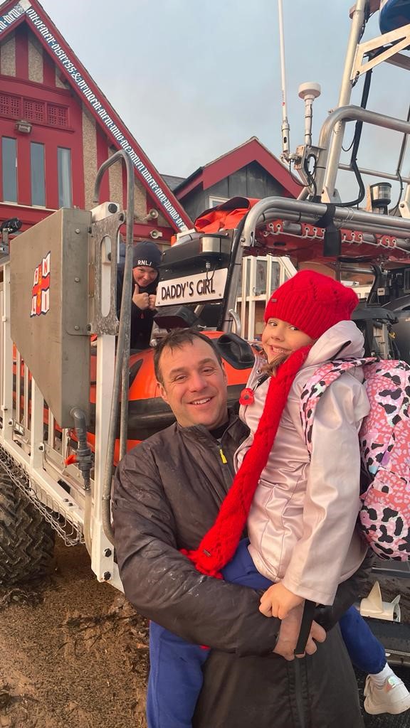 Peter with daughter Lily in front of Cullercoats lifeboat named Daddy's Girl