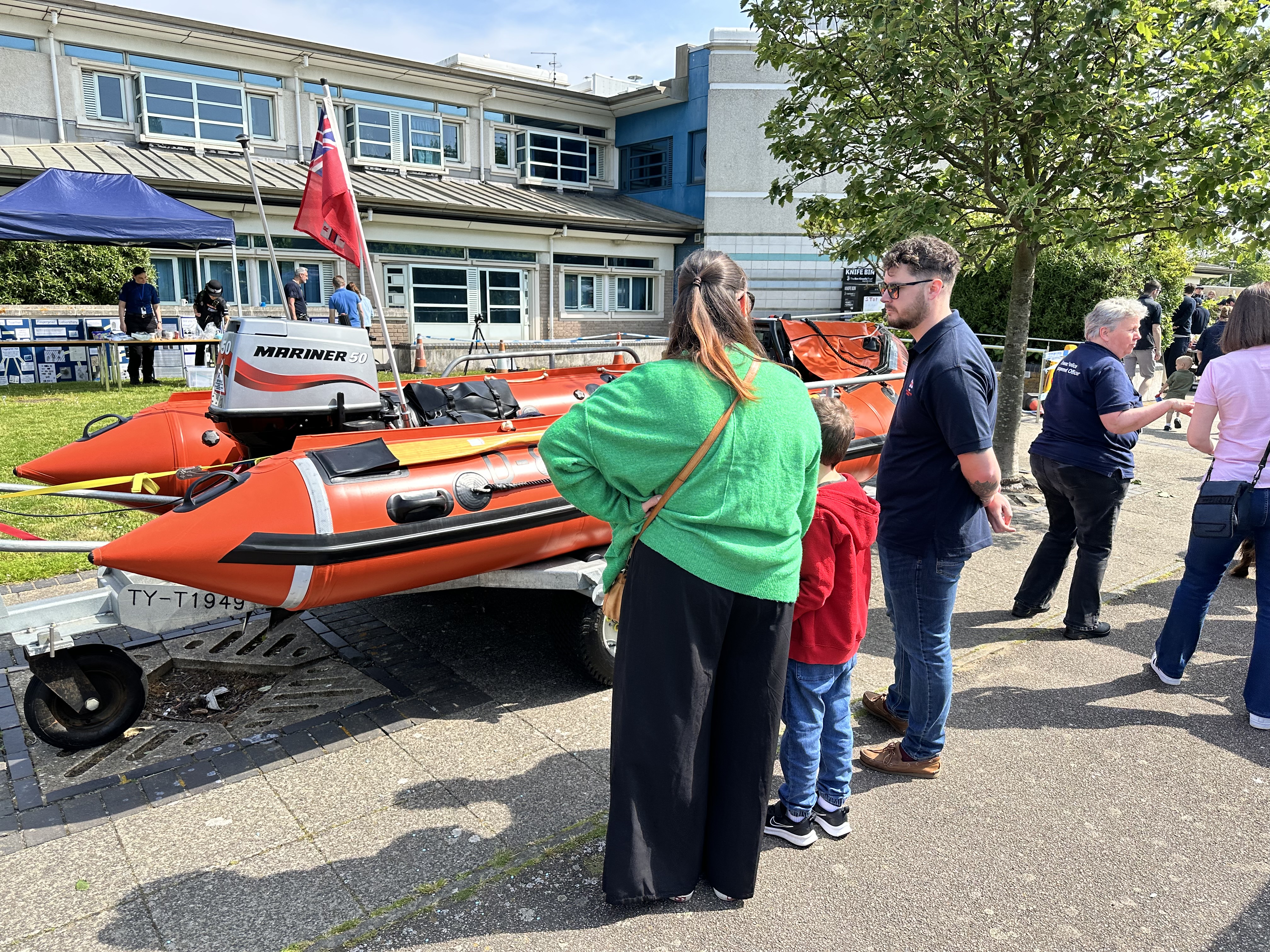 Volunteer crew member getting grilled by a young supporter.