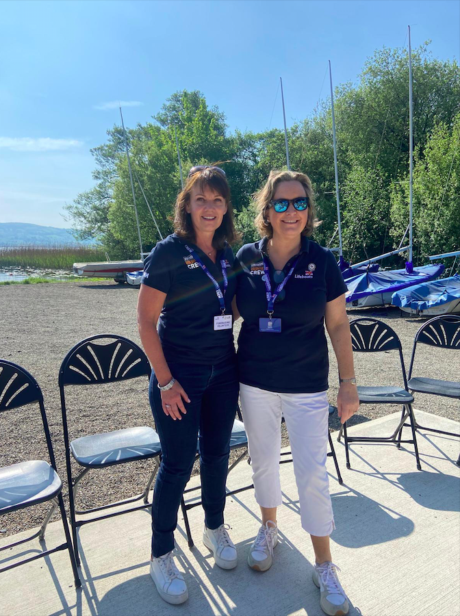 Ena Butler and Laura Clarke, Chairperson of Lap the Lake Charity Cycle 2024, in their RNLI t-shirts at Killaloe Sailing Club, waiting for the first of the cyclists to arrive