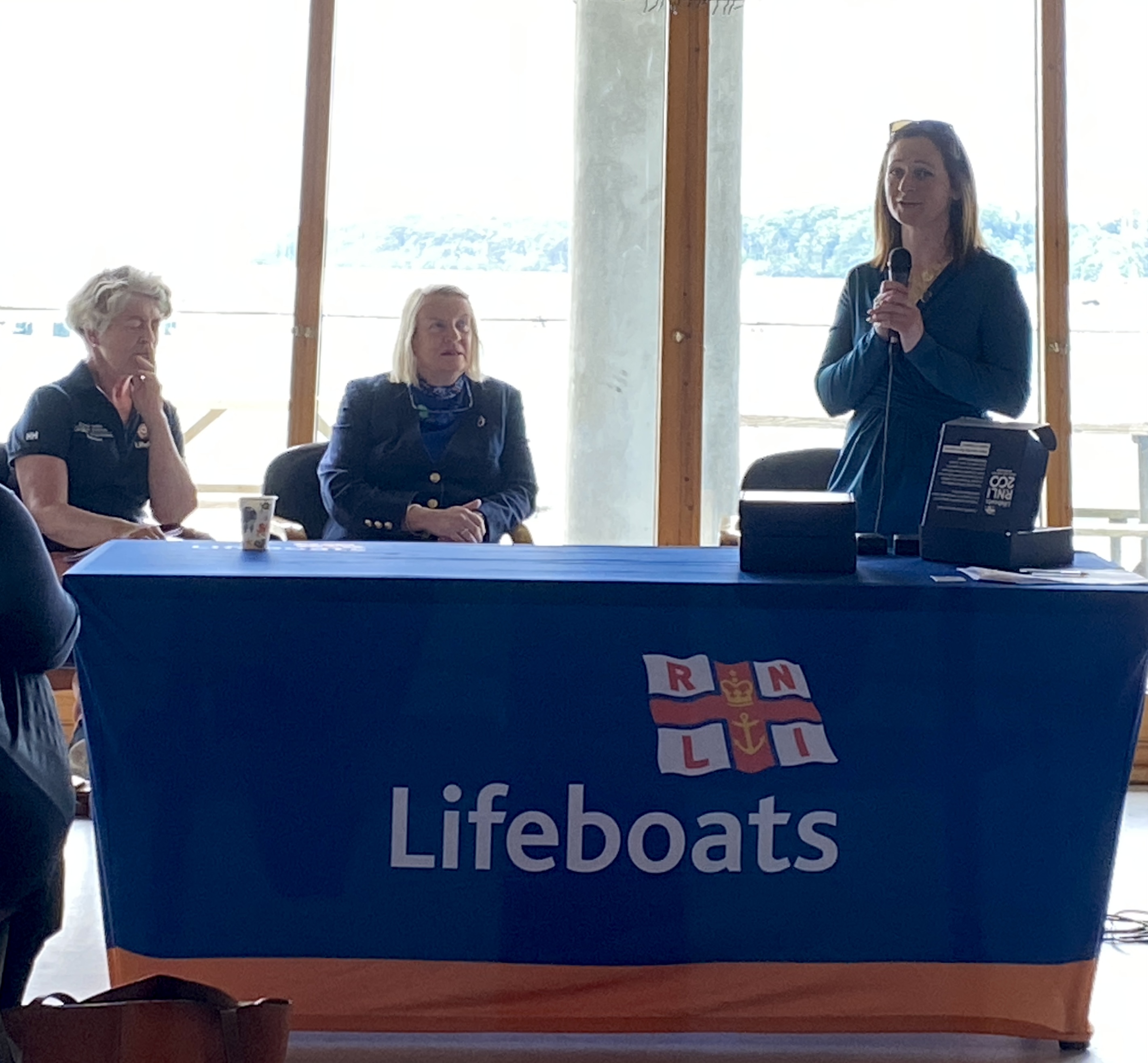 Lisa Hollingum, Area Lifesaving Manager is giving a speech, Lough Derg is visible behind her