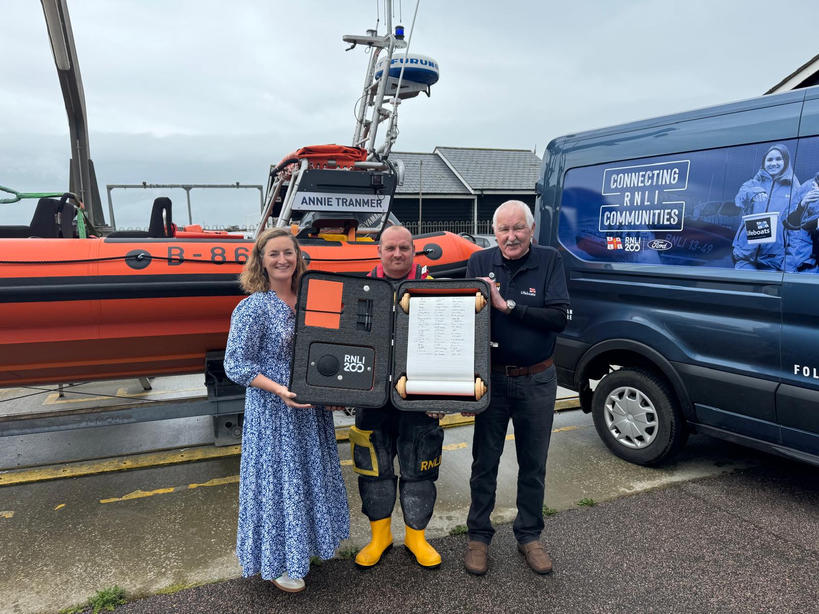 Representatives of Southwold Lifeboat Crew, Fundraisers and Shop with the RNLI 200 scroll.