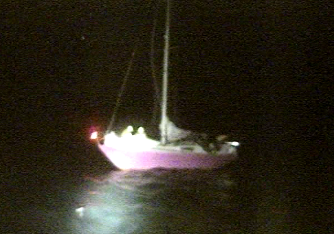 The yacht Pink Delta with two Padstow RNLI crew aboard assisting the skipper
