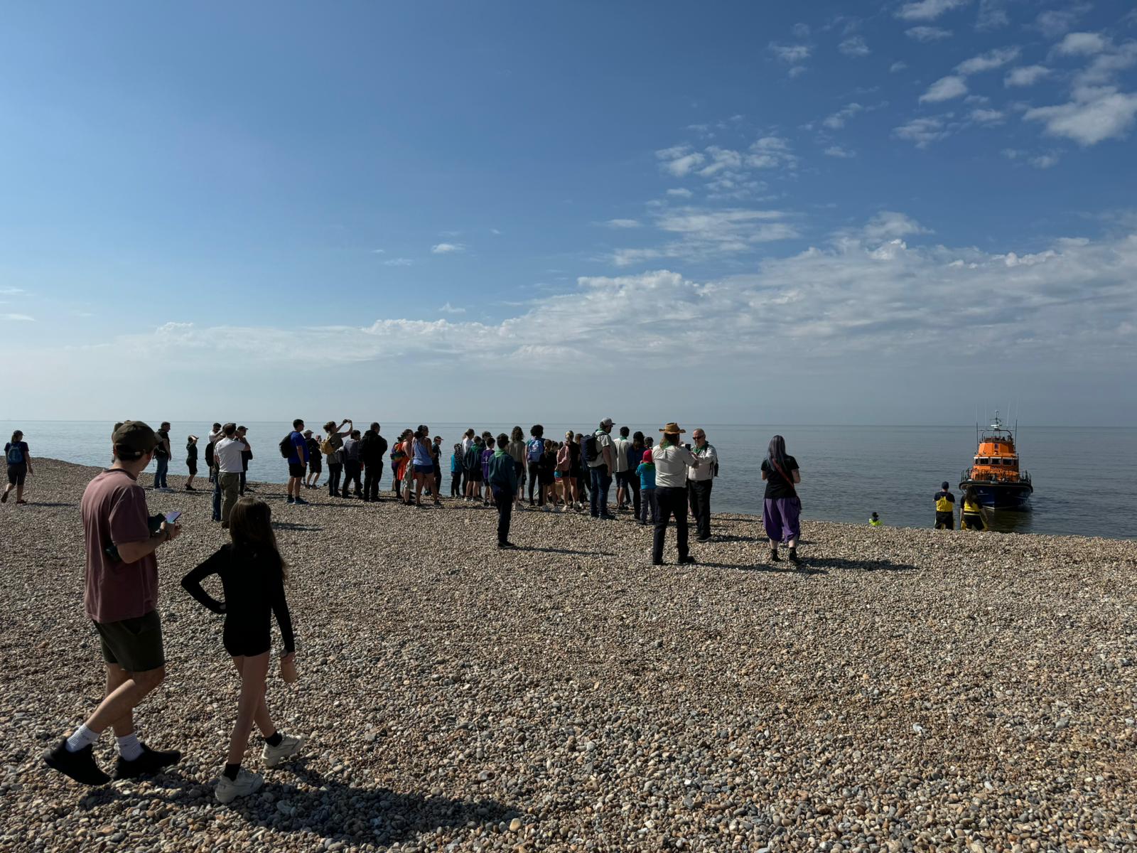 Looking at the sea with groups of walkers going to see the lifeboat