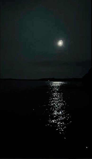 A white flare igniting in the night key, that resembles a moon