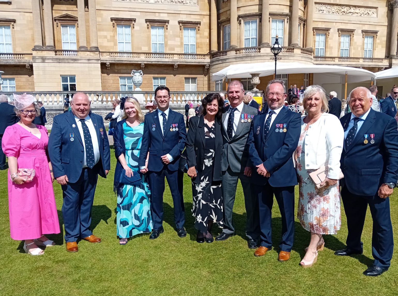 Penarth RNLI with partners at Buckingham Palace Garden Party in the sunshine with BP in background